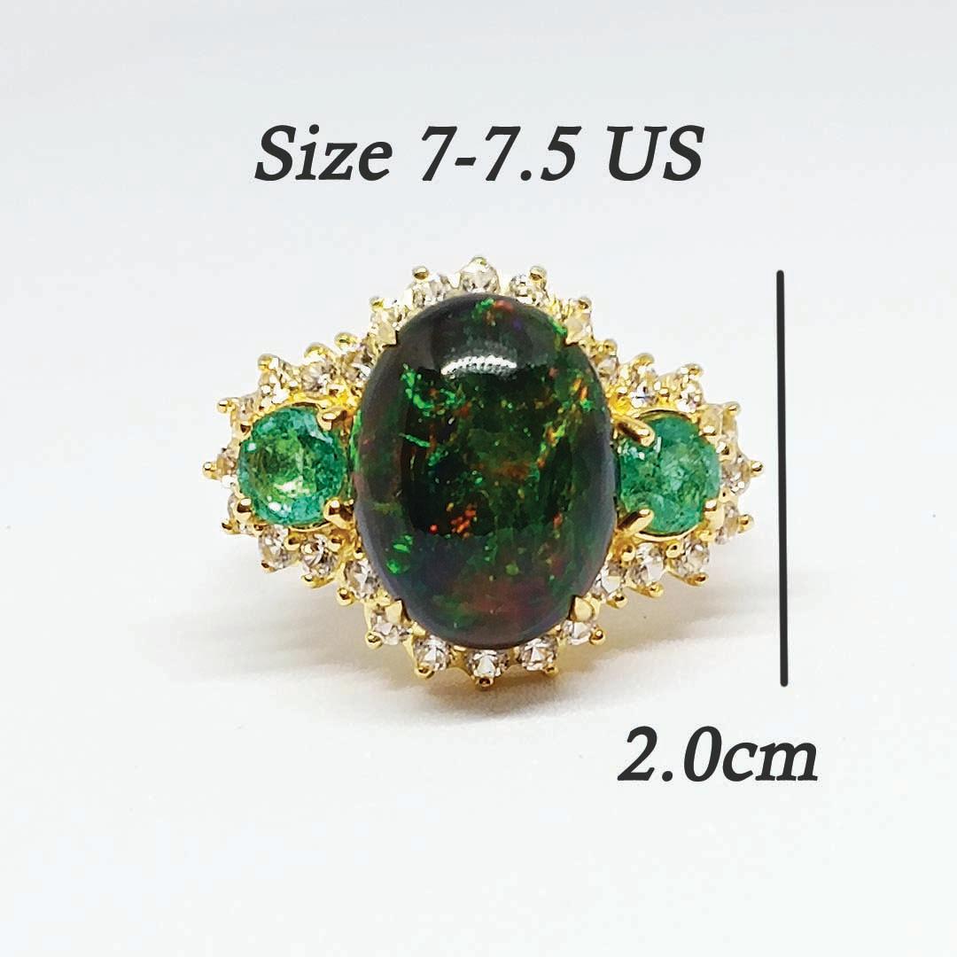 Black Opal cabochon Oval 15.5 x 12 x 7 mm. (7.5 cts)
Emerald  round . 5.5 mm. 2 pcs. ( 1.20 cts.)
white zircon round 2.10 mm. 28 pcs.
Sterling Silver on 18K Gold Plated.
Ring Size 7-7.5 US.
