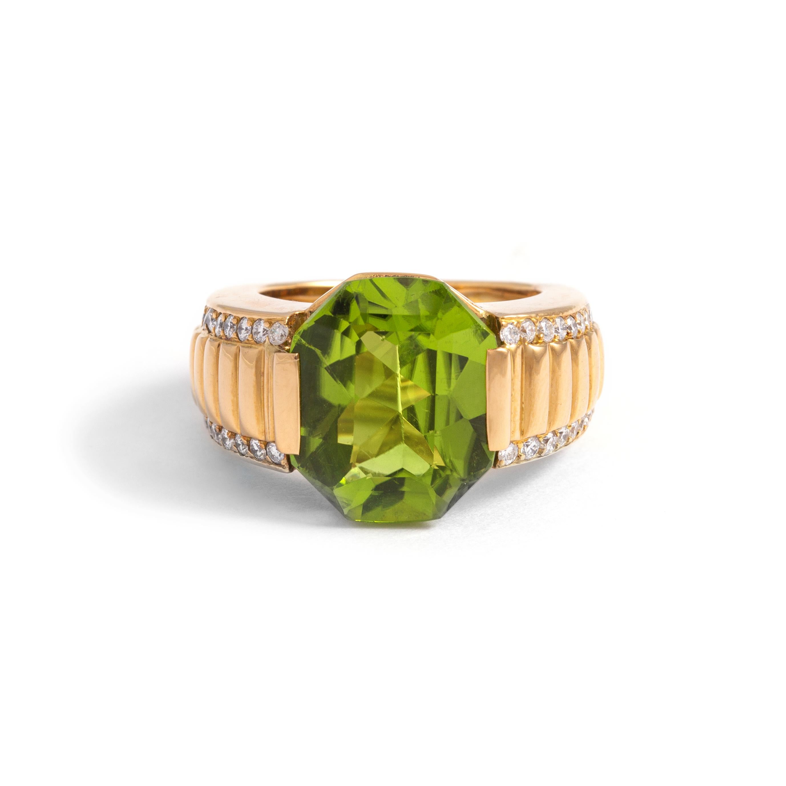7.50 carat Peridot shouldered by Diamonds on Gold Ring.
