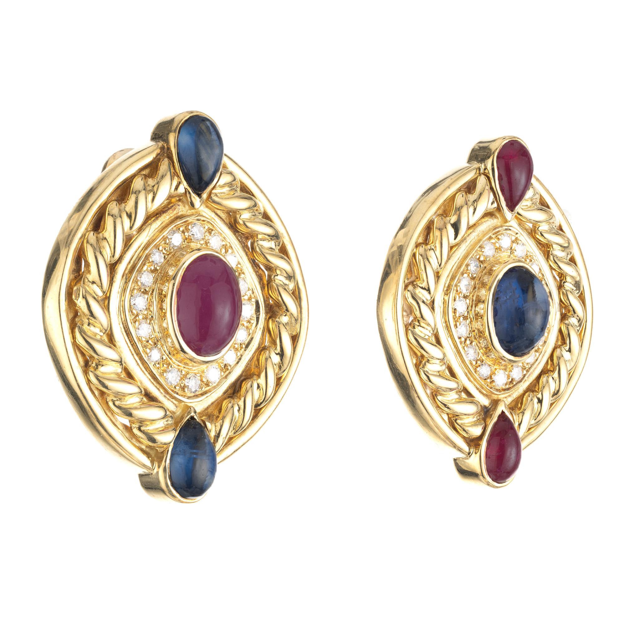 Mid-Century 1950's Heavy swirl clip post earrings. These large 18k yellow gold earrings consist of a total of 6 cabochon stones, 3 rubies and 3 sapphires. Each center stone is accented with a halo of full cut diamonds. True example of the 1980's