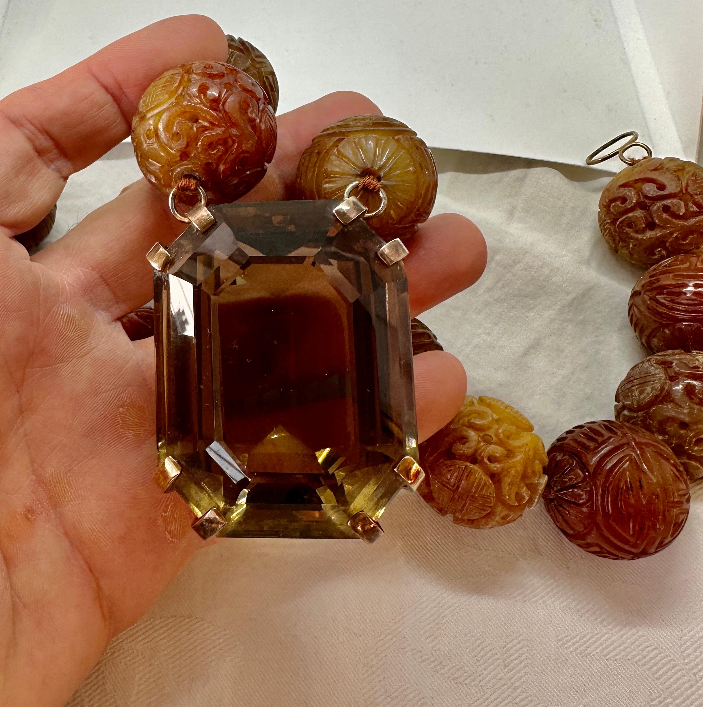 THIS IS A SPECTACULAR AND RARE ANTIQUE 750 CARAT SMOKY TOPAZ AND LARGE CARVED JADE BEAD PENDANT NECKLACE FROM THE ESTATE OF HOLLYWOOD ACTRESS MARY LOU DAVES WITH AN ABSOLUTELY EXTRAORDINARY MONUMENTAL EMERALD CUT 750 CARAT SMOKY QUARTZ.  THE SMOKY