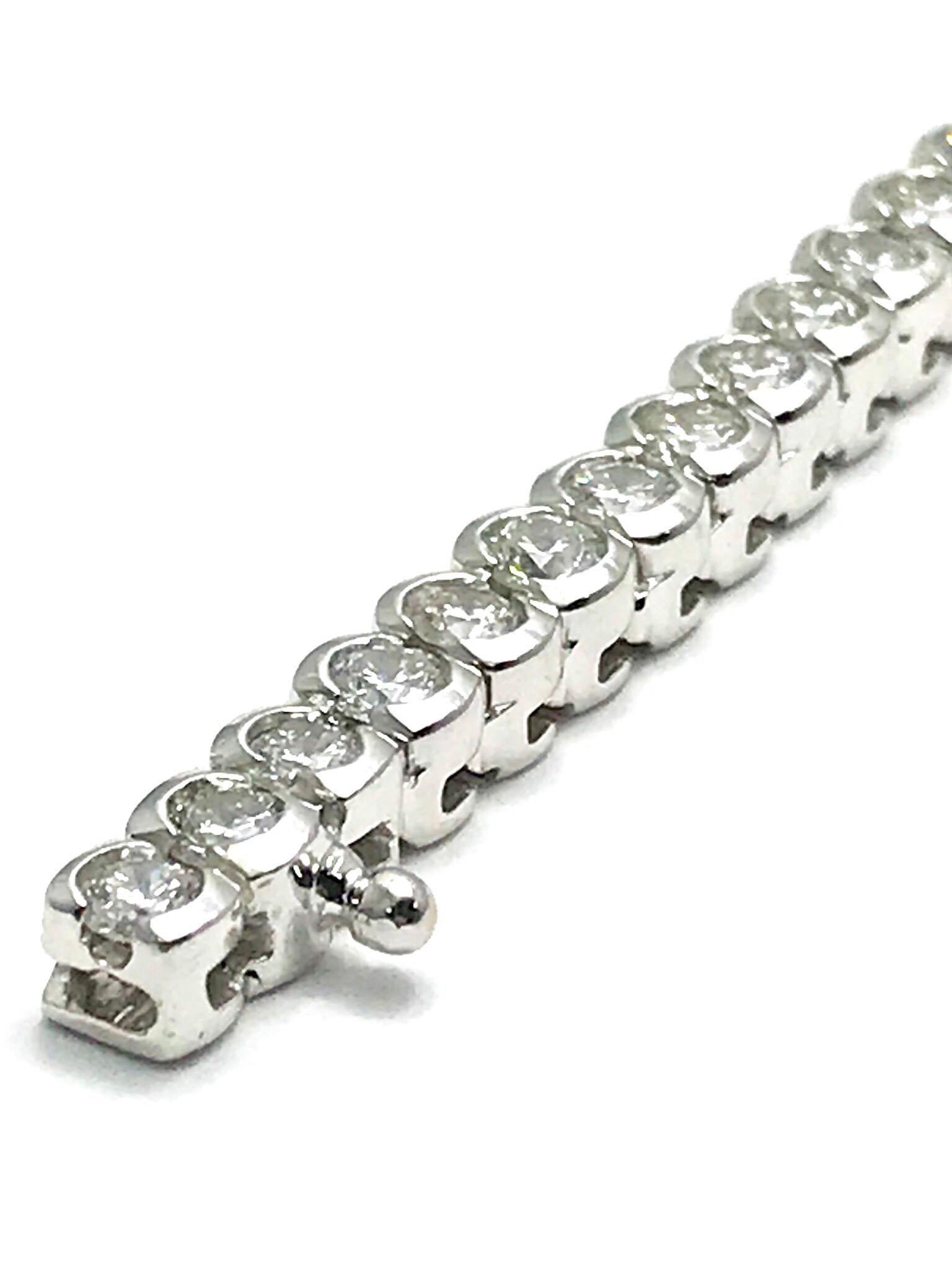 This is a stunning 7.50 carat round brilliant Diamond tennis bracelet in 18 karat white gold.  The Diamonds are half bezel set, and graded as F-G color, VS2-SI1 clarity.  The bracelet has a simple push button clasp with a safety.  It is 7.00 inches