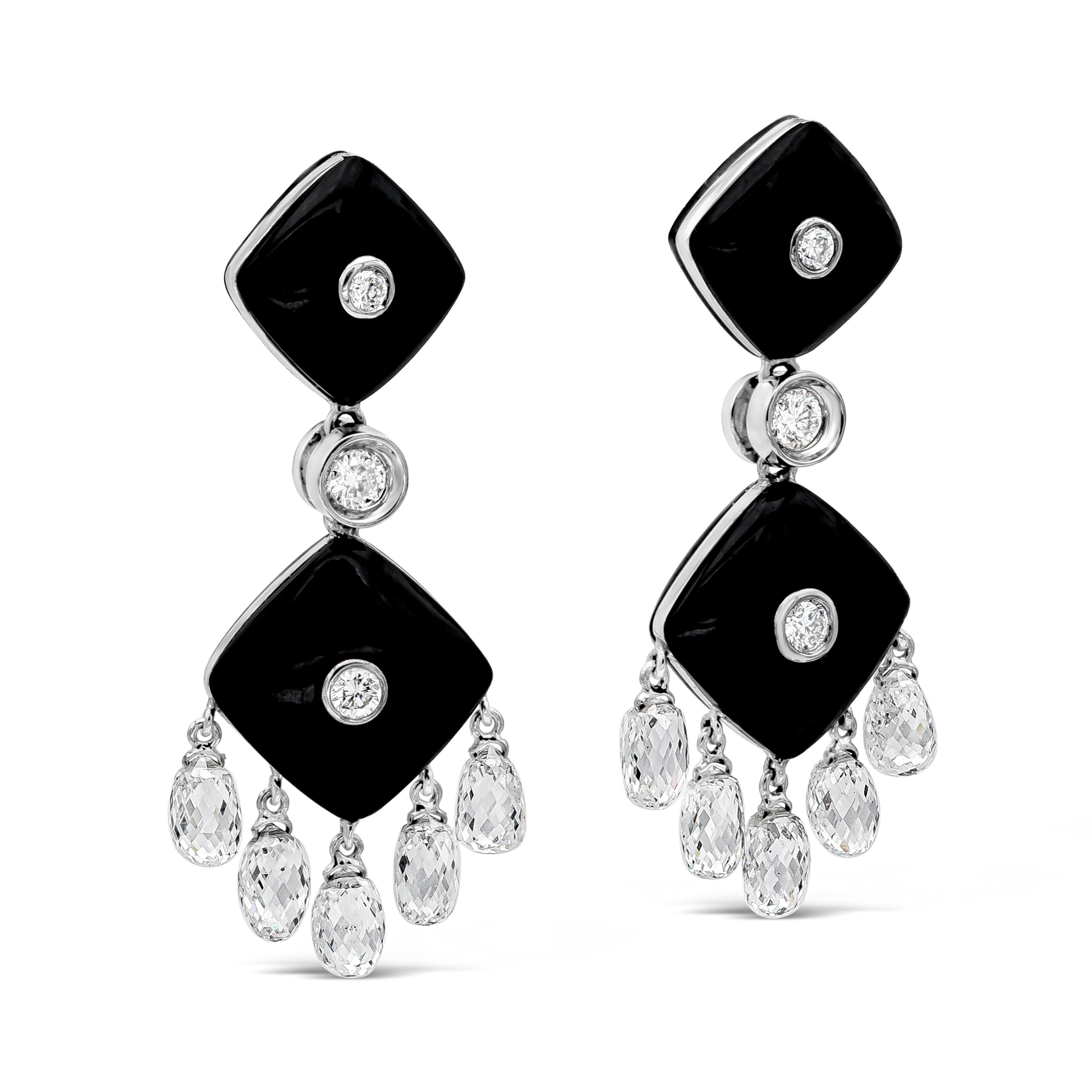 A stylish pair of drop earrings showcasing onyx that weigh a total of 7.50 carats. Brilliant round diamonds are placed on the center of both onyx and one round diamond links the two black onyx together. Total weight of round diamonds are 0.14 carats