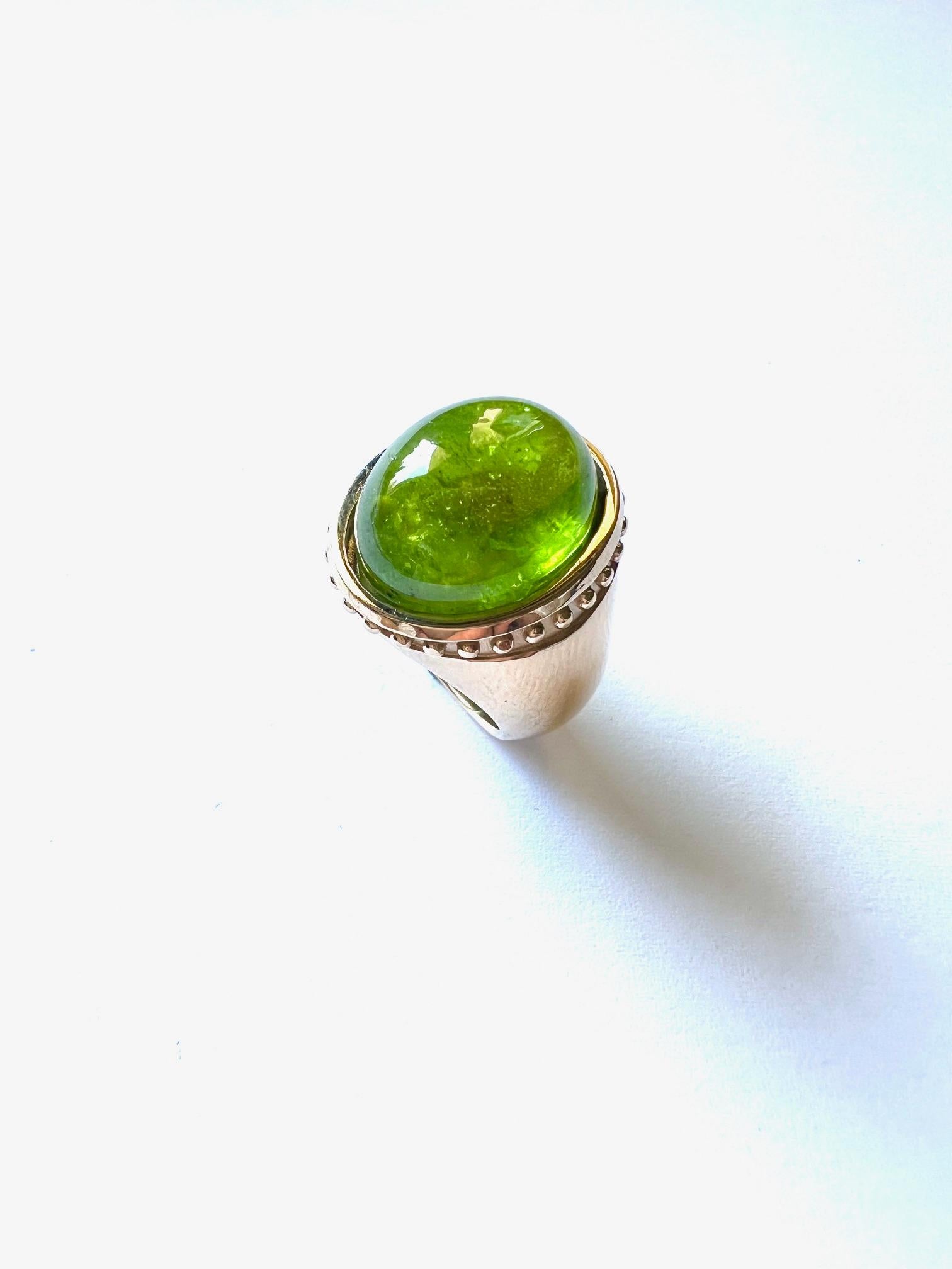 This ring has a contempary design with 1 large Peridot Cabouchon as an eyecatcher.