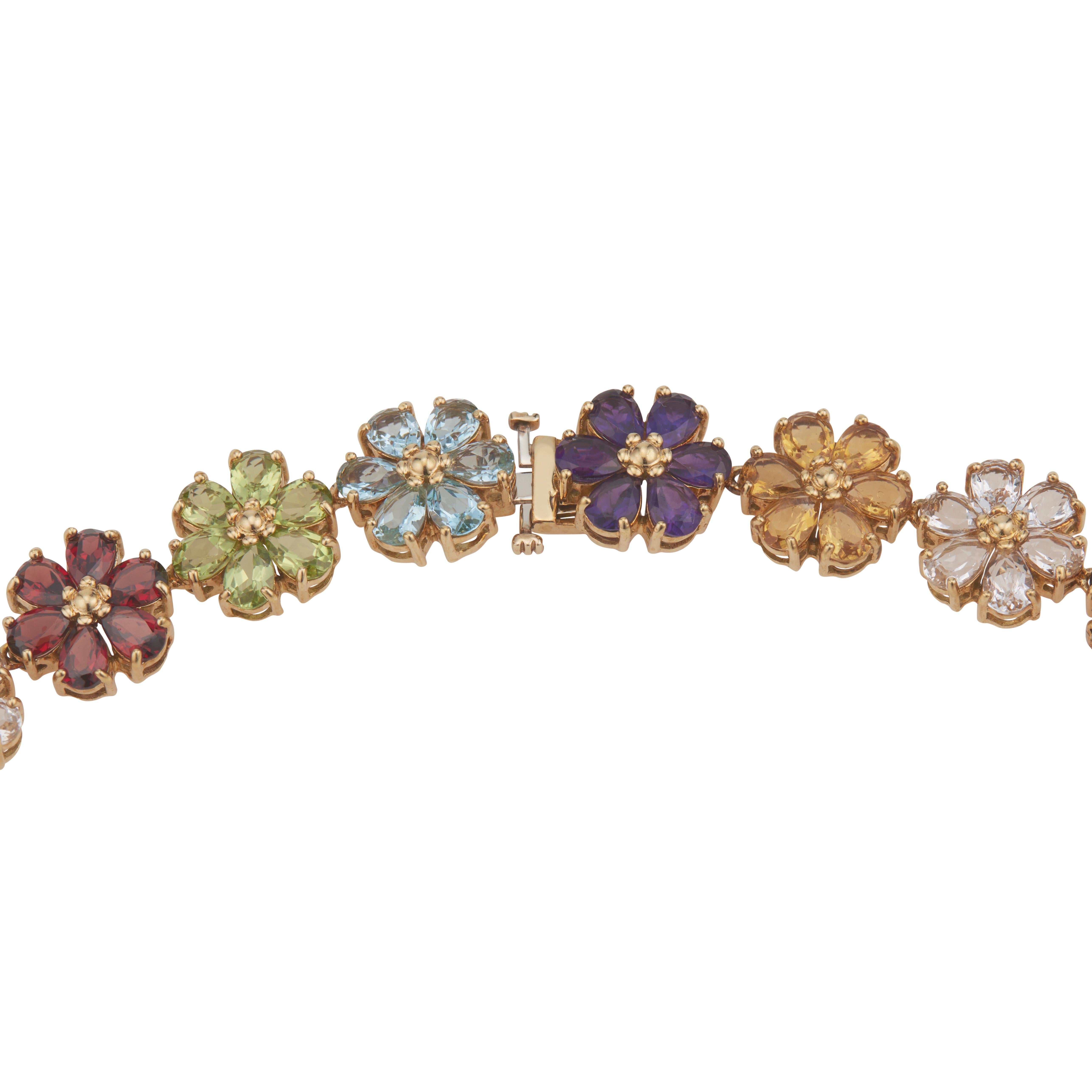 1960's Multi-stone gold necklace. Amethyst, Citrine, Topaz, Garnet, Peridot and white Topaz flower clusters set in 18k yellow gold. 17.50 inches in length. 

30 Pear shaped amethyst  approx. total weight 10.50cts
30 Pear shaped citrine total weight