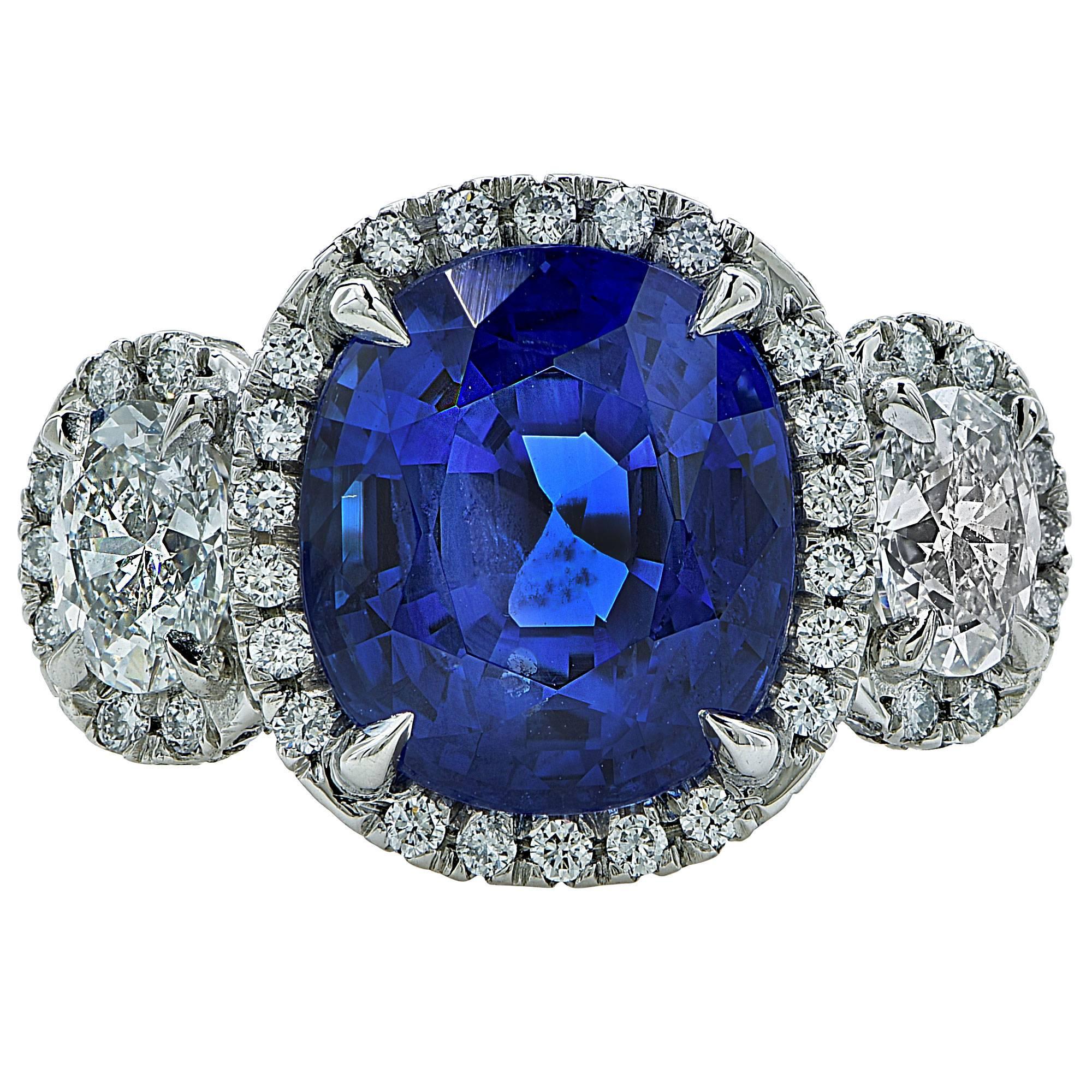 This Gorgeous Blue Ceylon Sapphire catches the eye with it's amazing vivid color. The 7.51 carat cushion cut sapphire has been certified by the AGL and comes with a certificate. The ring also features another 1.85 carat total weight of side diamonds