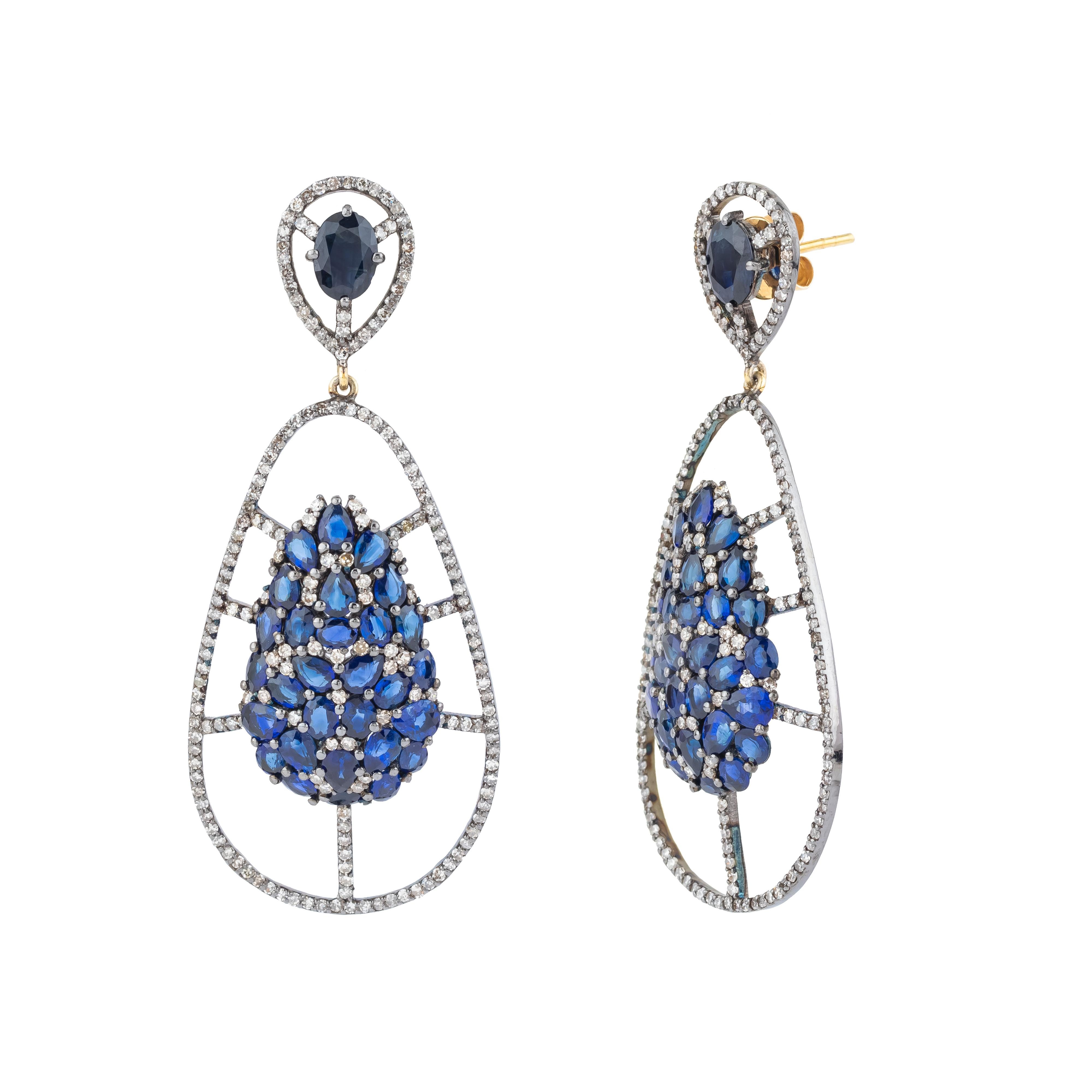 A brilliant display of elegance and craftsmanship, the 7.51 Carat Diamond and Sapphire Cocktail Earrings are an extraordinary blend of radiant diamonds and deep, luxurious sapphires. Each earring showcases a dazzling array of meticulously cut