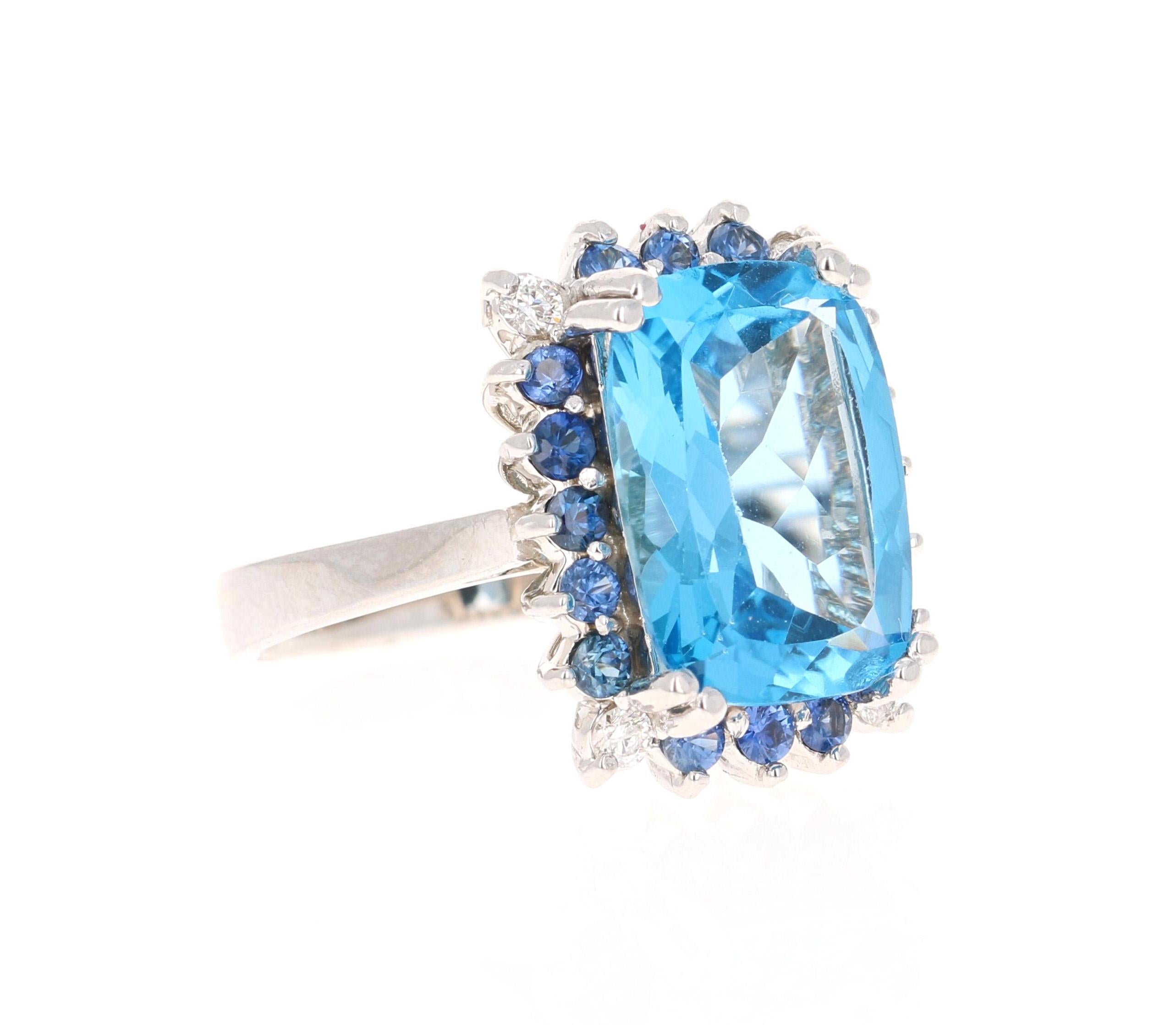 This stunning statement ring has a large Cushion Oval Cut Blue Topaz that weighs 6.70 carats. 
The blue topaz is 11 mm x 15 mm. 
It is surrounded by a halo of 4 Round Cut Diamonds that weigh 0.12 carats with a clarity of SI and color of F. It also