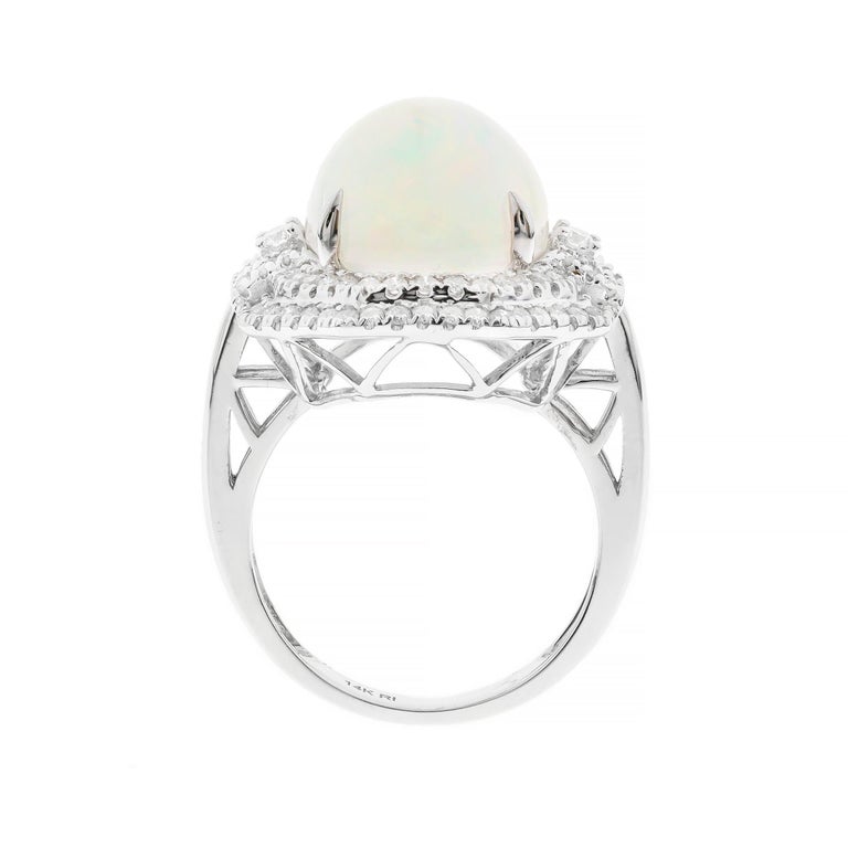 Decorate yourself in elegance with this Ring is crafted from 14-karat White Gold by Gin & Grace. This Ring is made up of 12x16 mm Oval-Cab (1 pcs) 7.52 carat Ethiopian Opal and Round-cut White Diamond (84 Pcs) 0.73 Carat. This Ring is weight 6.20
