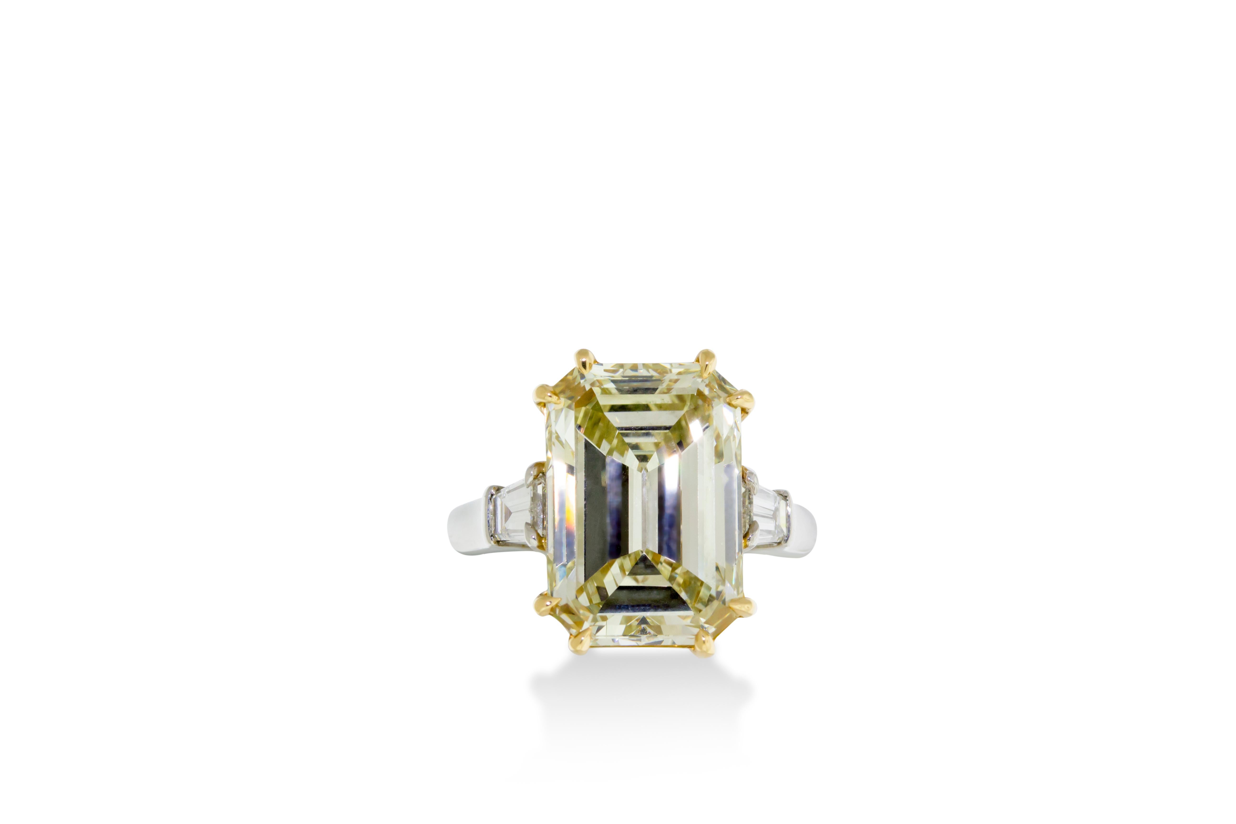 A 7.52 VVS2 fancy light yellow emerald cut diamond flanked on either side by a tapered baguette cut diamond. Mounted in 18K yellow gold and platinum. GIA certified. Report No. 2165553057. Size 6.  

Resizing available upon request. 

Viewings