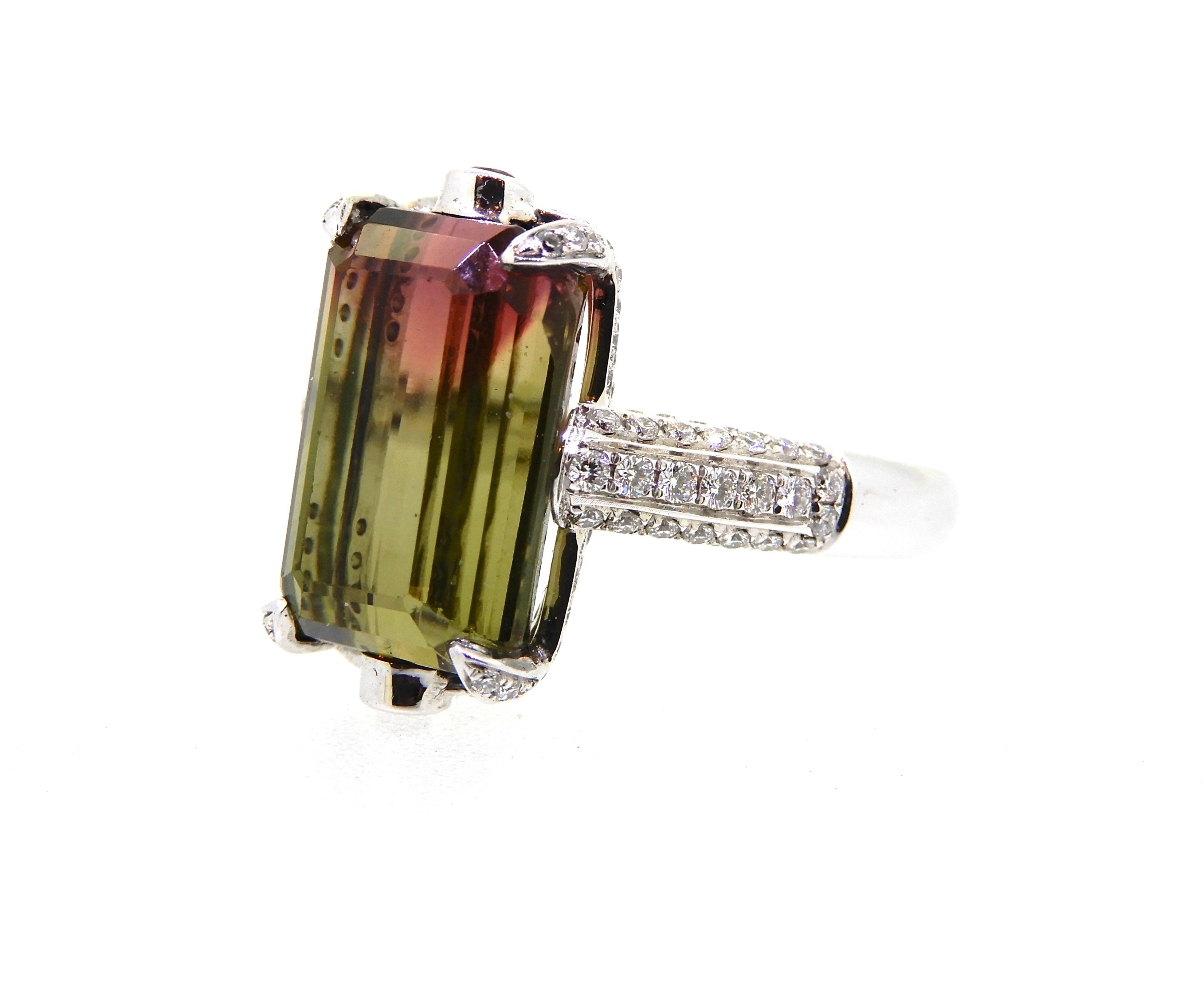 Standing out from the rest is this 7.53 Carat Modified Emerald Cut Bi Colour Tourmaline and Diamond Cocktail Ring. It has a lovely rounded, flat edge band, which splits into a split under-rail, each with one row of five micro claw set round