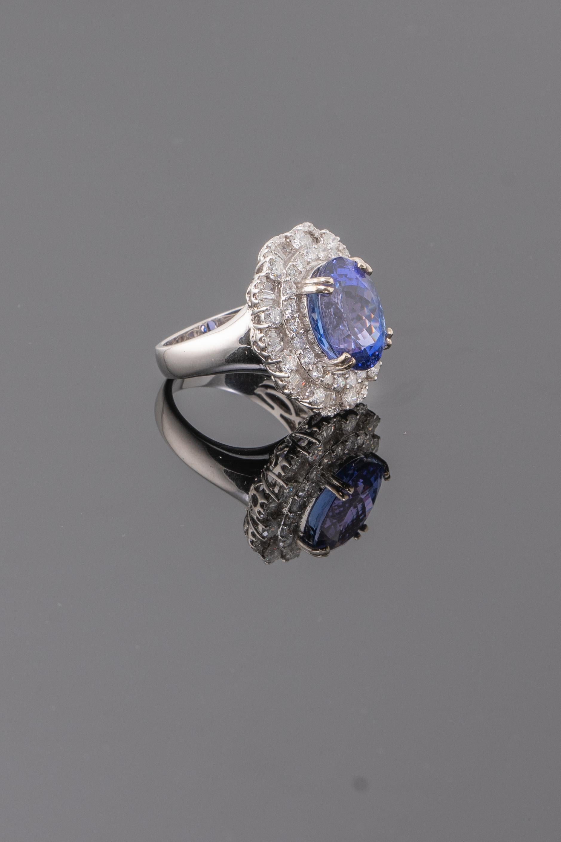 Treat yourself to a true blue beauty with this Tanzanite and Diamond cocktail ring! The natural 7.54 carat Tanzanite has a great color and luster, with absolutely no inclusions. Around 2.2 carat of VS quality round and baguette White Diamonds are