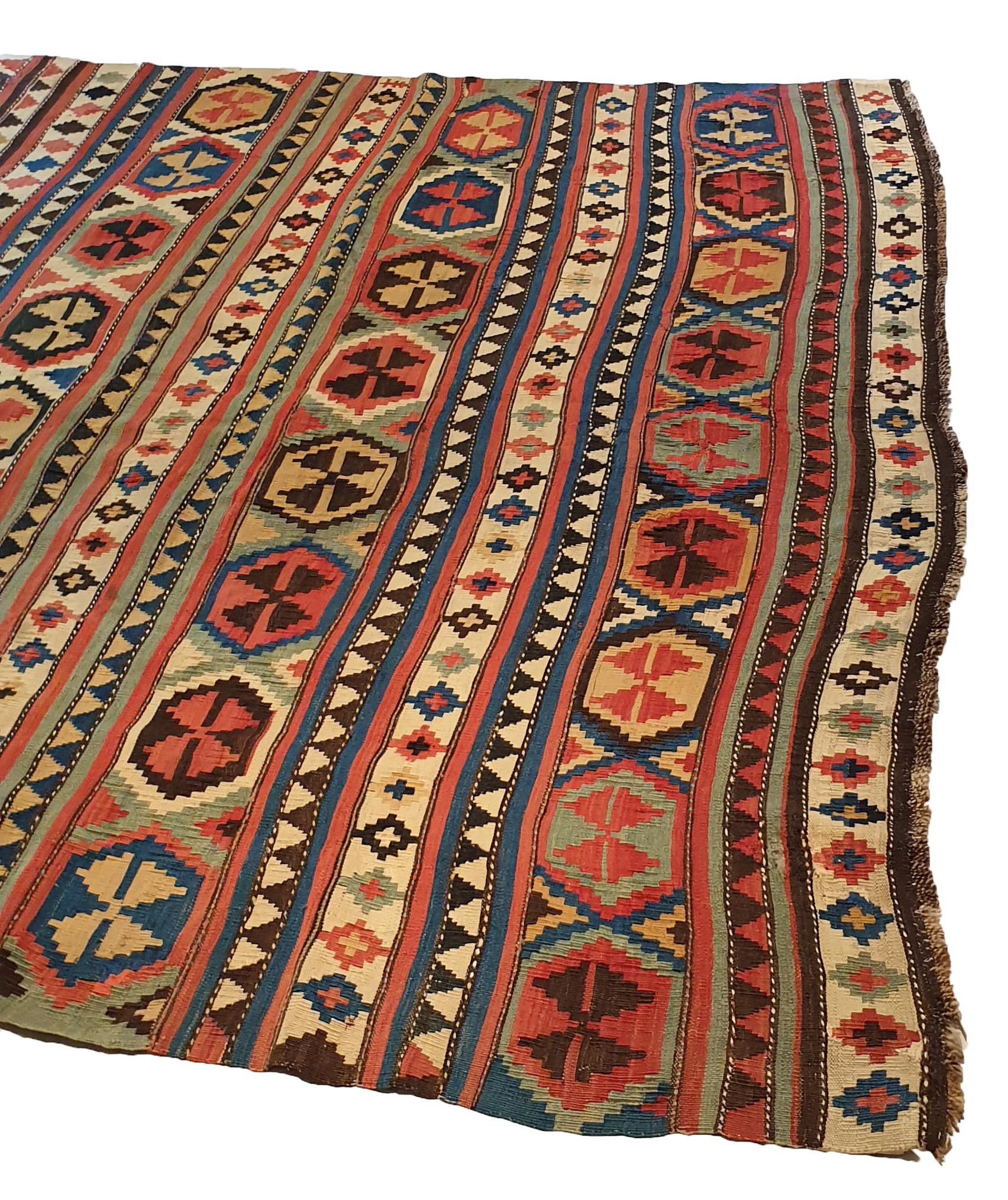 754 - Very nice large Kilim from the end of the 19th century with a superb geometric design and pretty natural colors, with blue, red, pink, brown and green. Entirely woven by hand with wool on cotton base.