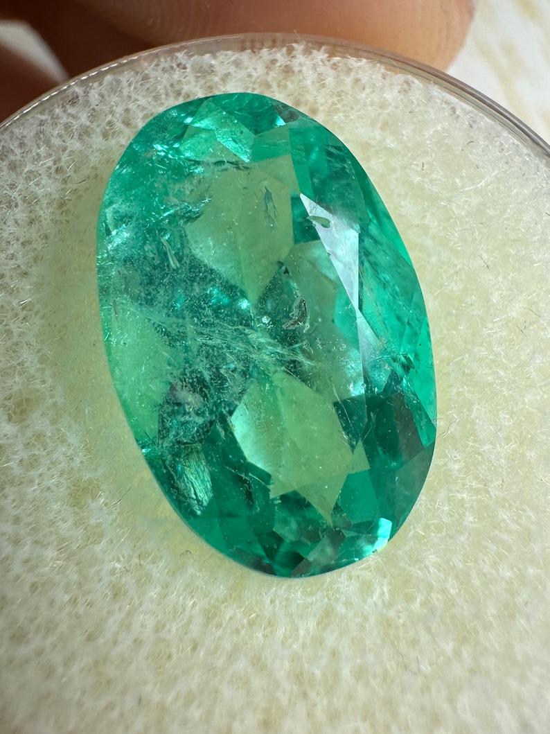 Stone: Emerald
Weight: 7.55-carats
Shape: Oval Cut
Clarity: Transparent
Luster: Very Good
Color: Bluish Green
Measurements: 15.80mm x 10.24mm x 8.32mm
Geographic Origin: Colombia
Treatment: Natural, Oiling

Comments: Due to their growth conditions
