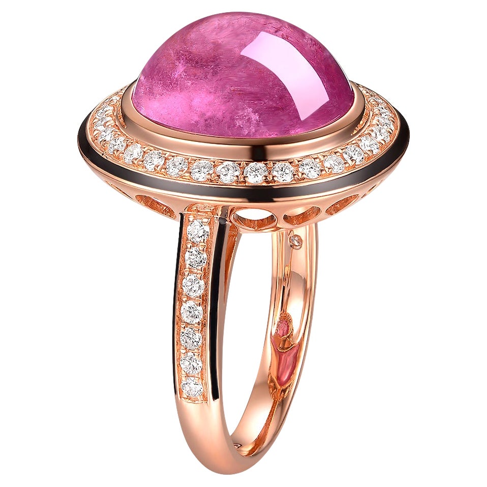 This striking ring features a captivating 7.55-carat cabochon pink tourmaline, set in a luxurious setting that showcases the gemstone's rich, saturated color and unique, smooth dome shape. The tourmaline is nestled within a halo of sparkling