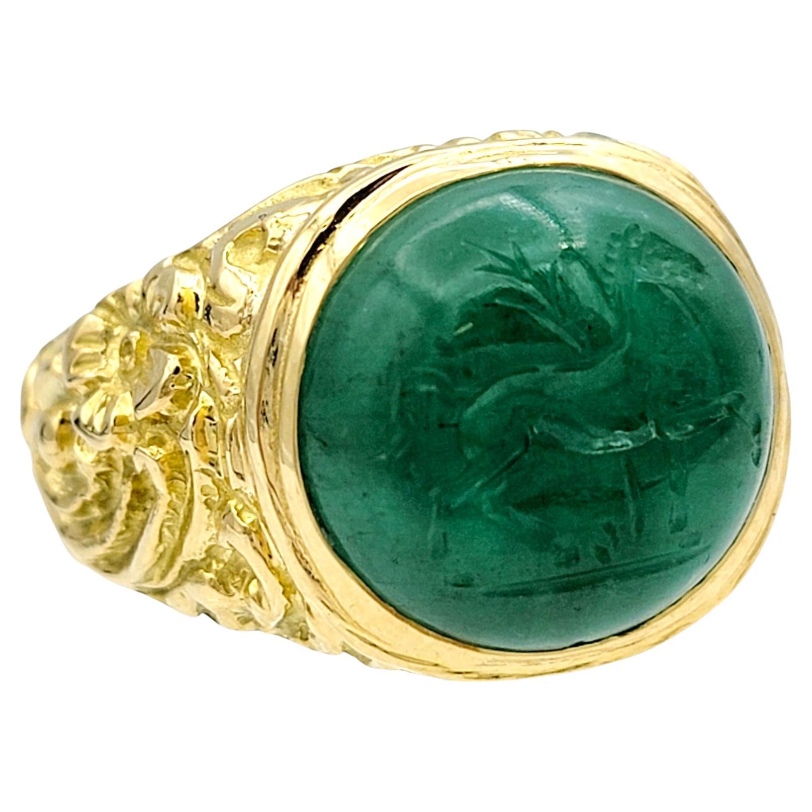 Ring Size: 9

Introducing a truly unique and captivating piece: this oval cabochon jade ring, featuring an intricately engraved horse intaglio, set in luxurious 18 karat yellow gold. The rich green jade, with its smooth cabochon cut, serves as the