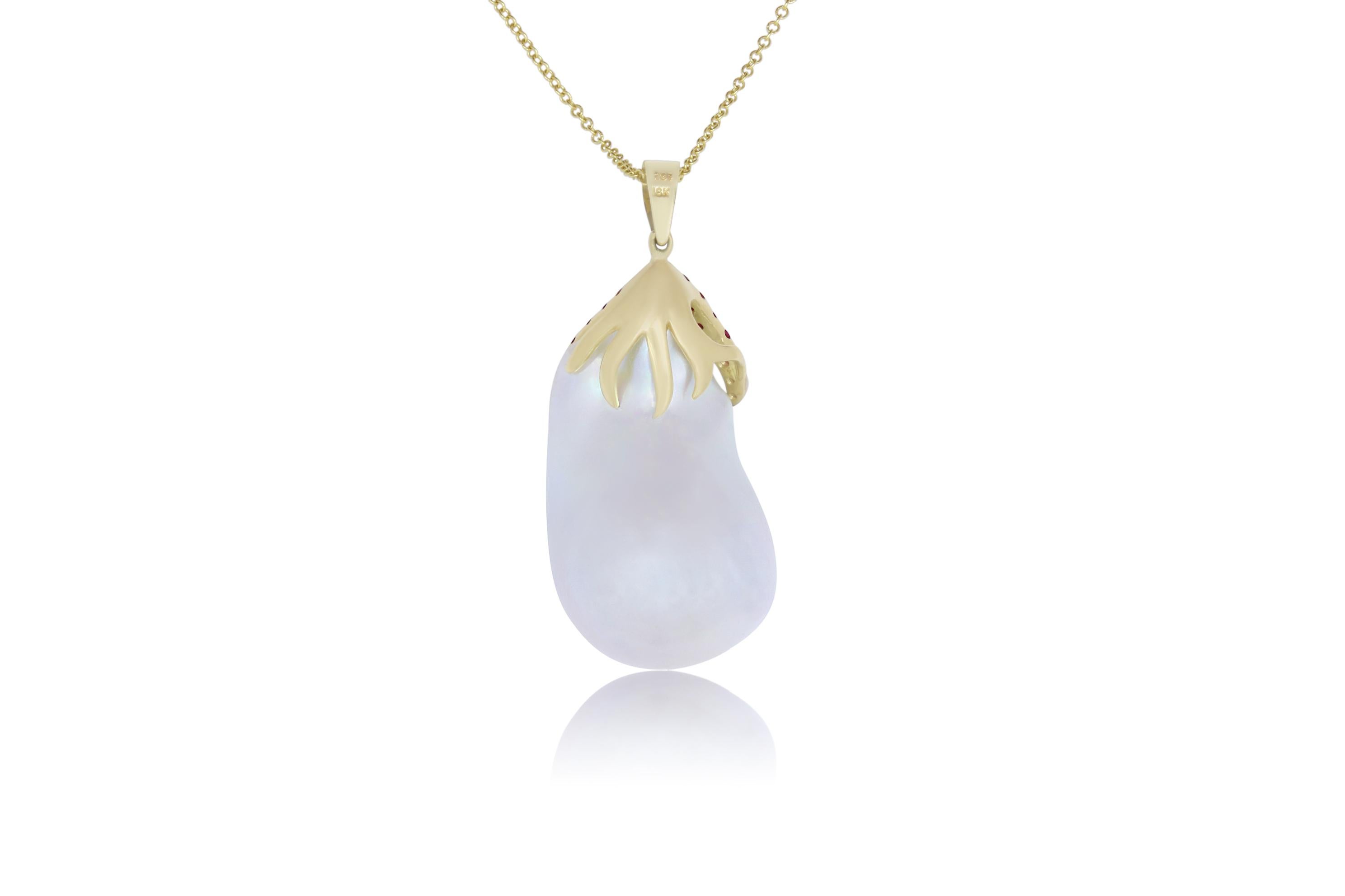 A one-of-a-kind piece, this 7.56 Carat White Pearl is adorned with Pink Sapphires and Diamonds. A truly unique piece that will have all eyes on you!

 Material: 18K Yellow Gold
Center Stone Details: 7.56 Carat Pearl
Mounting Stone Details:  19 Round