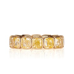 7.56ct Fancy Yellow Cushion Cut Diamond Bezel Set Eternity Band in 18K Yellow