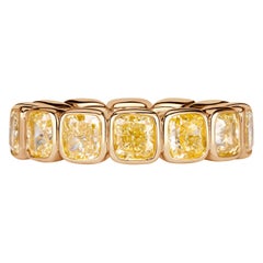 7.56ct Fancy Yellow Cushion Cut Diamond Bezel Set Eternity Band in 18K Yellow
