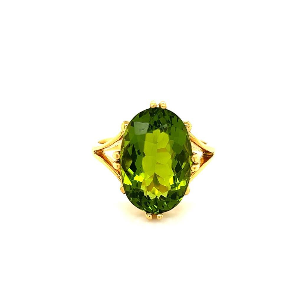 7.58 Carat Oval Peridot Handcrafted Solitaire Ring in 18 Karat Yellow Gold

This gorgeous ring features a magnificent, luscious Oval Peridot at its centre. This majestic jewel weighs 7.58 carats and is held in a claw setting on an expertly