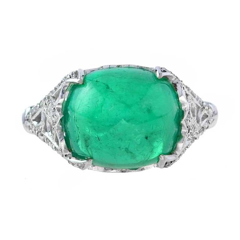 Discover our extraordinary one-of-a-kind Cabochon Colombian Emerald ring of all time! A magnificent sugarloaf shape Colombian emerald is the colorful centerpiece of this gorgeous antique bauble, elegantly handcrafted in 18K white gold.

The