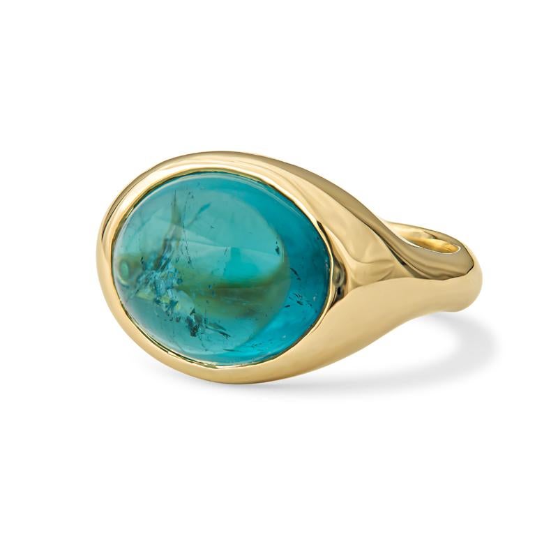 This ring features a 7.58ct oval cabochon teal tourmaline bezel set in a 14kt yellow gold ring. The ring itself is a size 6, but can be resized to be smaller or larger upon request.
