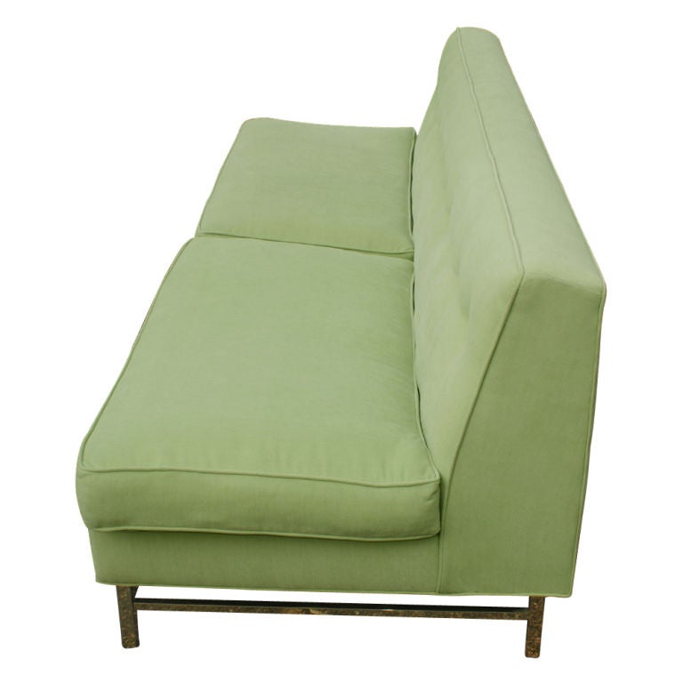 A Mid-Century Modern sofa designed by Harvey Probber. Mint green upholstery with a button tufted back and two detached seat cushions on a bronze anodized base. Size: 7.5ft.