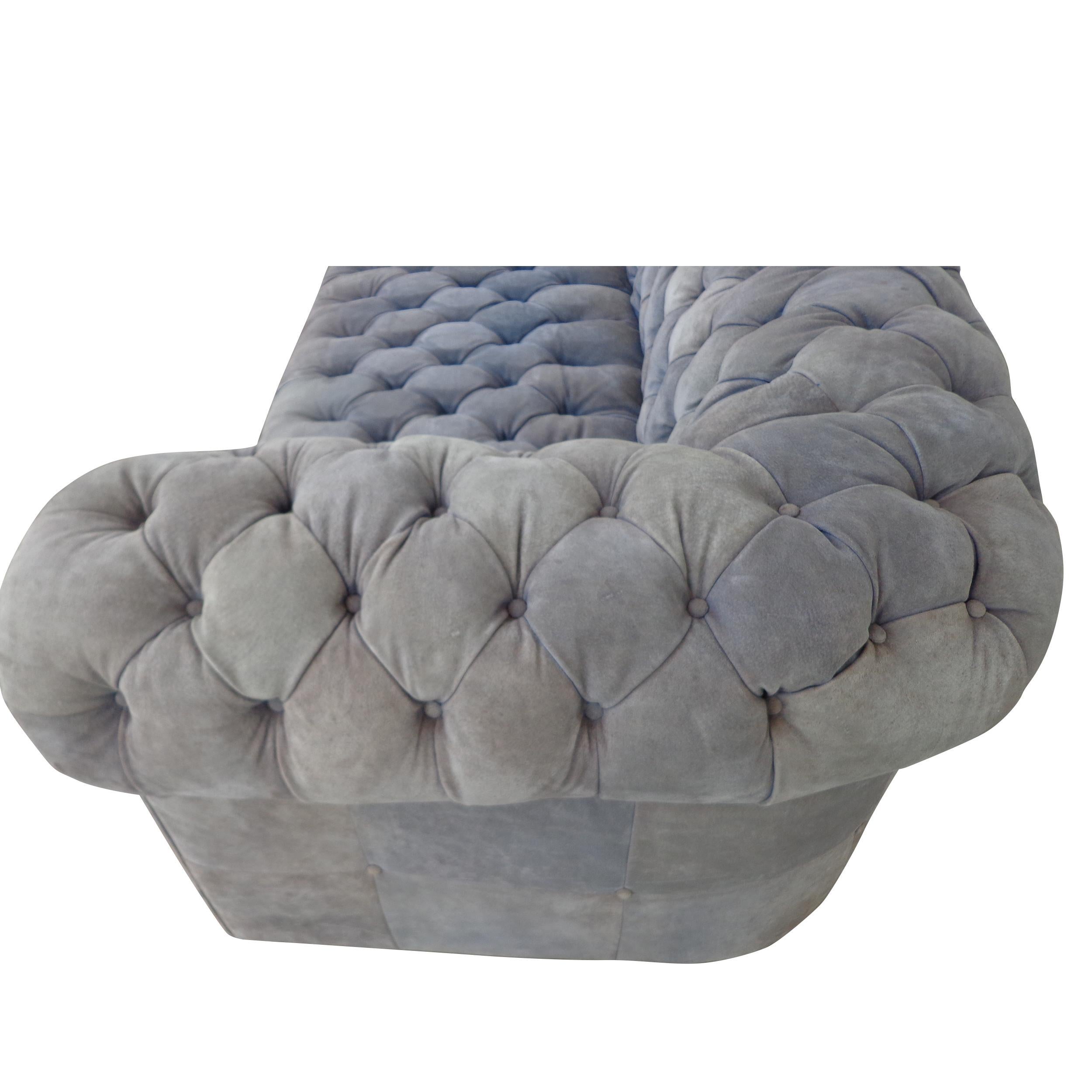 Dunbar Style Chesterfield tufted sofa in Suede

Sofa in Grey suede on a plinth base. Traditional button tufting. 
Reupholstery recommended.

Measures: Seat Height 17