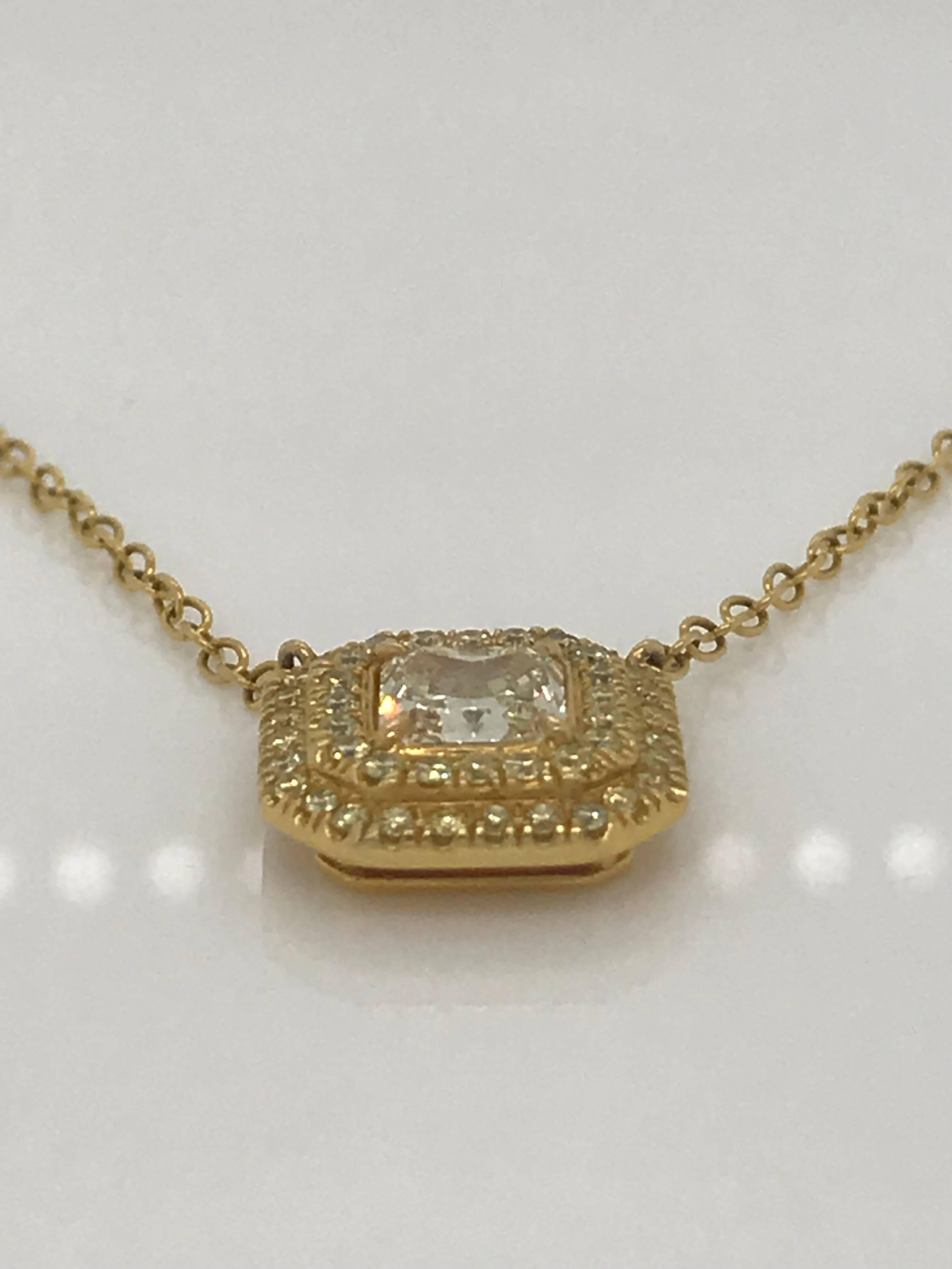 This 18k Yellow Gold Pendant features a fancy yellow, radiant cut diamond weighing .76 carats. The 48 round brilliant cut diamonds that make up the halos are also yellow and total .45 carats.  Total weight of pendant is 1.21. The chain is 16 inches. 