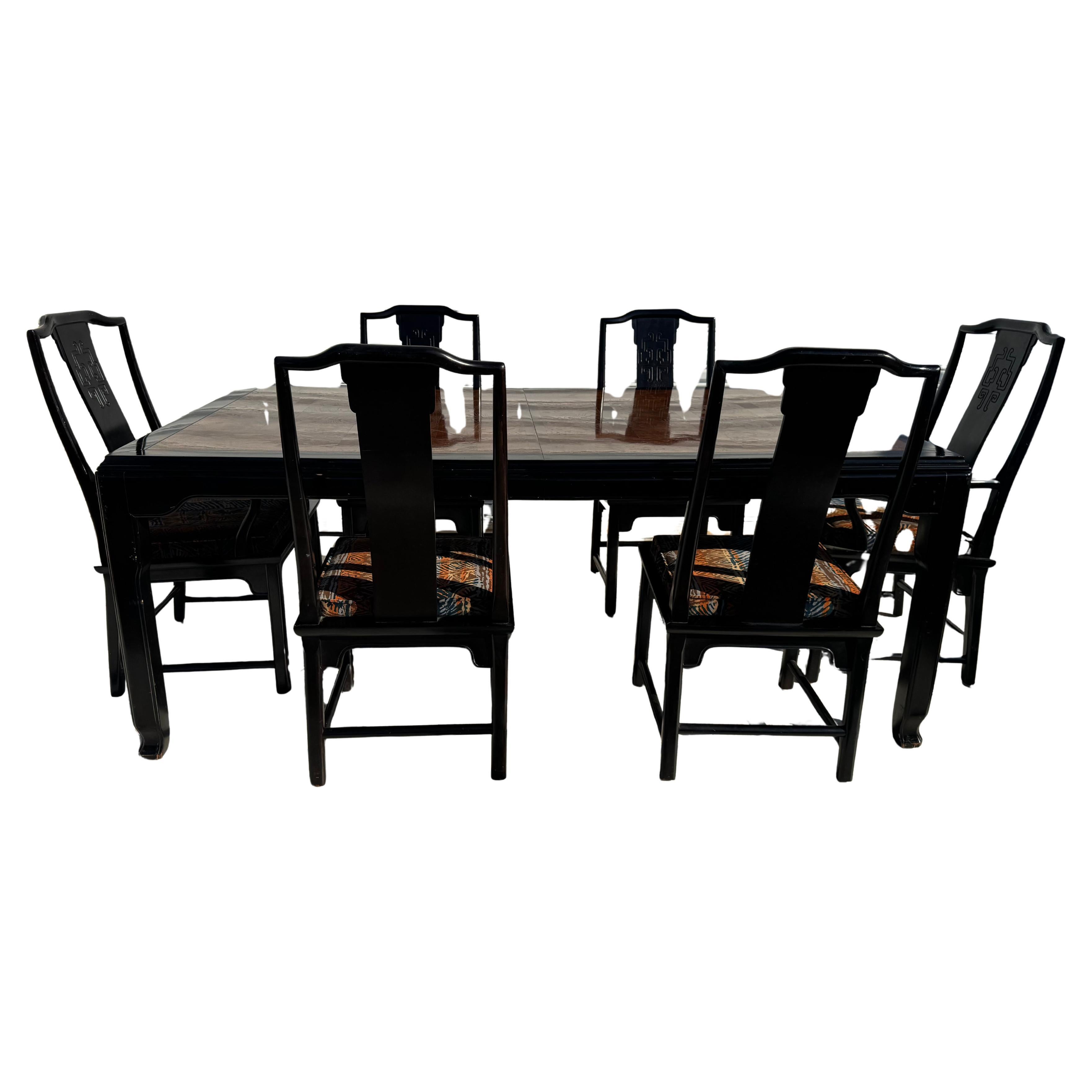 Chin Hua dining table and chairs by Century Furniture.

Dining table designed for the Chin Hua Collection for Century Furniture. 
Ebonized dark brown frame with rich burl wood inset. 

There are 6 chairs that accompany the the table.
2 arms and 4