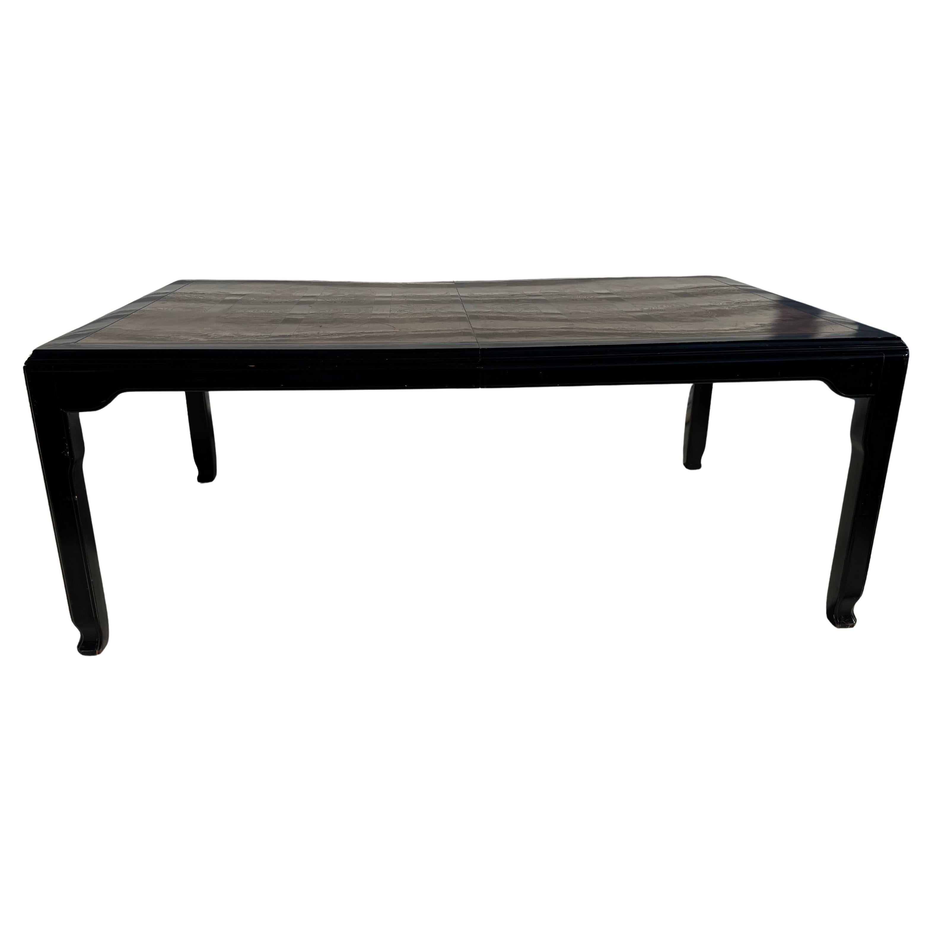 Chin Hua dining table by Century Furniture.

Dining table designed for the Chin Hua Collection for Century Furniture. 
Ebonized dark brown frame with rich burl wood inset. 
 
Measures: 30
