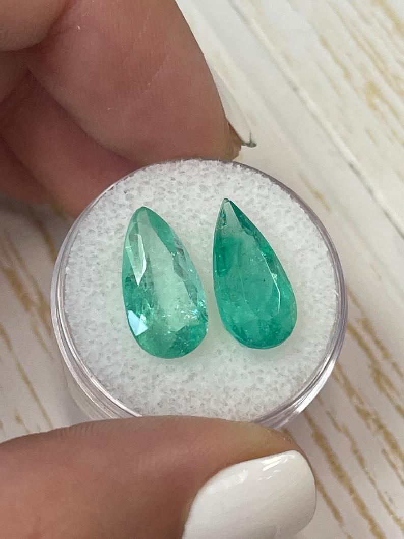 Stone: Emerald
Total Weight: 7.60-tcw
Shape: Pear Cut
Clarity: Transparent
Luster: Very Good
Color: Medium Green
Measurements: 15.69mm x 8.17mm x 7.09mm // 15.06mm x 8.00mm 5.05mm
Geographic Origin: Colombia
Treatment: Natural, Moderate Oil,
