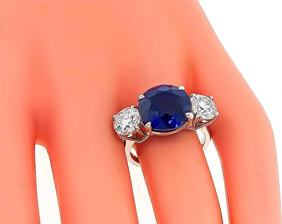 This amazing platinum ring is centered with a large round cut sapphire that weighs 7.61ct. Accentuating the sapphire are two sparkling round cut diamonds that weigh approximately 2.02ct. graded G-H color with VS2-SI1 clarity. The top of the ring