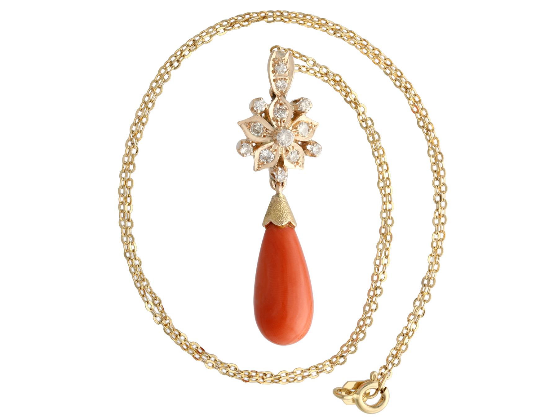 A fine and impressive vintage 7.62 carat coral and 0.40 carat diamond, 14 karat yellow gold pendant and chain; part of our diverse vintage jewelry and estate jewelry collections.

This stunning, fine and impressive coral vintage pendant has been