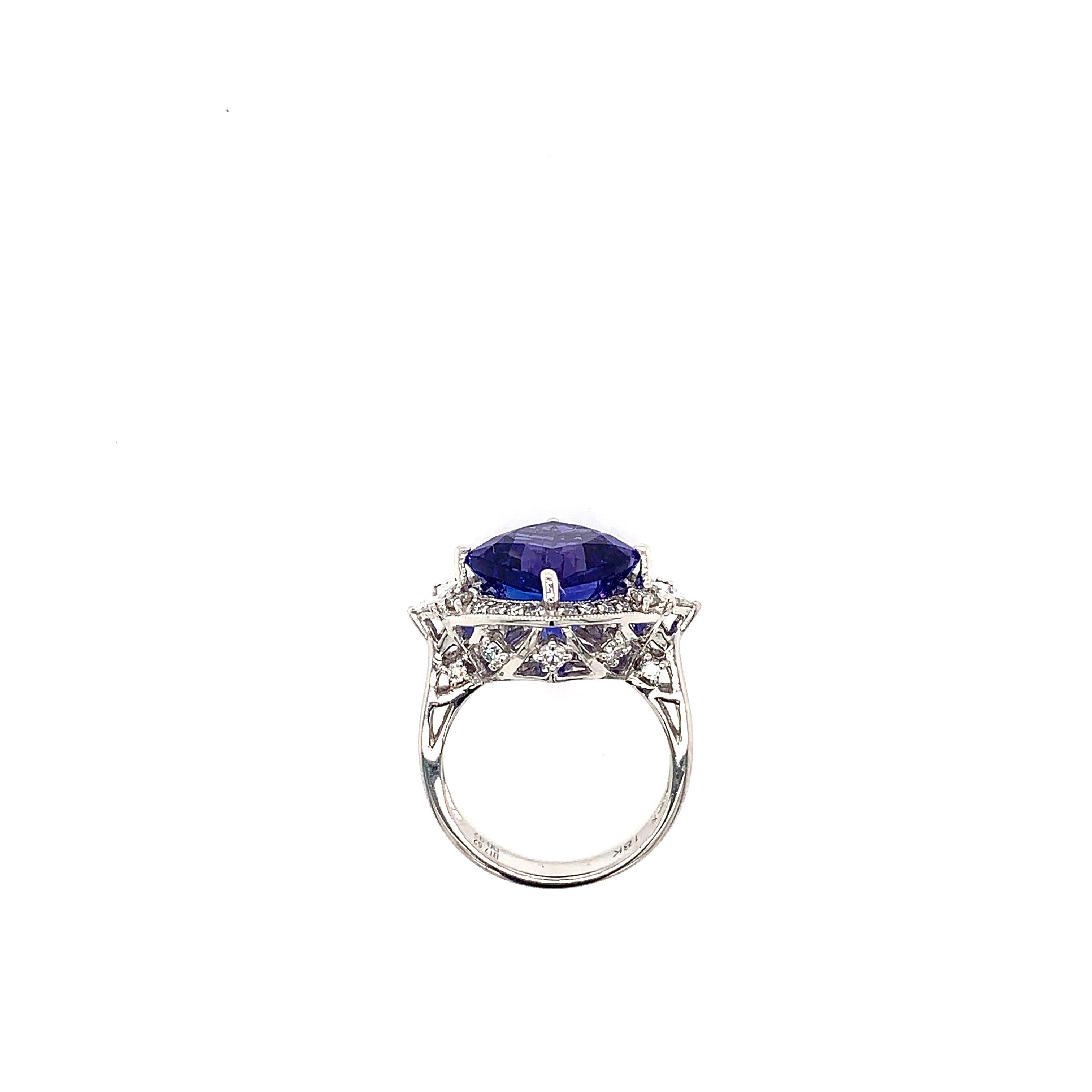 Classic tanzanite ring in 18K white gold with diamonds. 

Tanzanite: 7.62 carat cushion shape.
Diamonds: 0.92 carat, G colour, VS clarity. 
Gold: 5.512g, 18K white gold. 