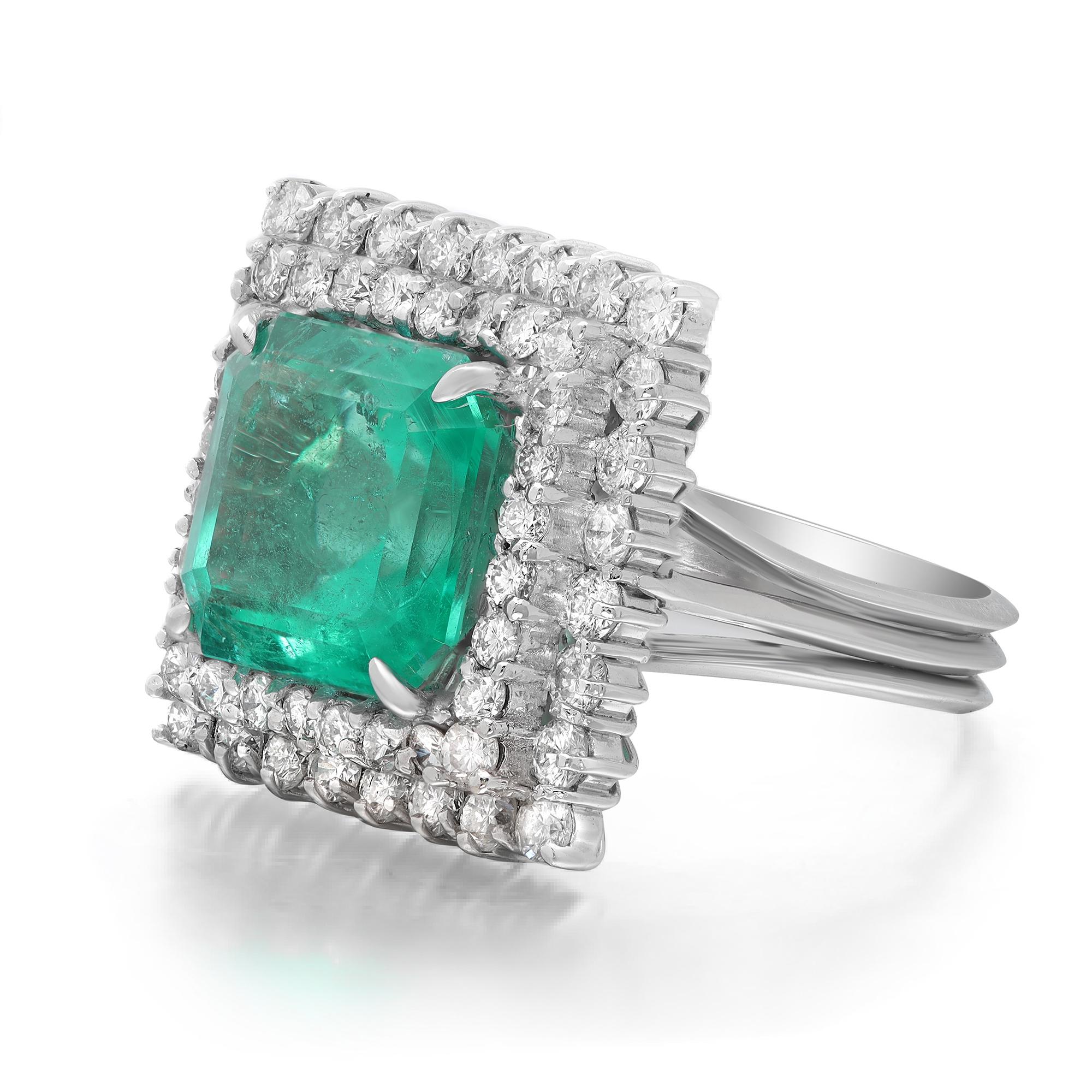 This stunning ring features a prong set square shaped green Emerald weighing 7.62 carats that sits atop a halo of bright white sparkling round brilliant cut diamonds weighing 2.06 carats. Crafted in 18k white gold. Ring size: 7. Total weight: 10.76