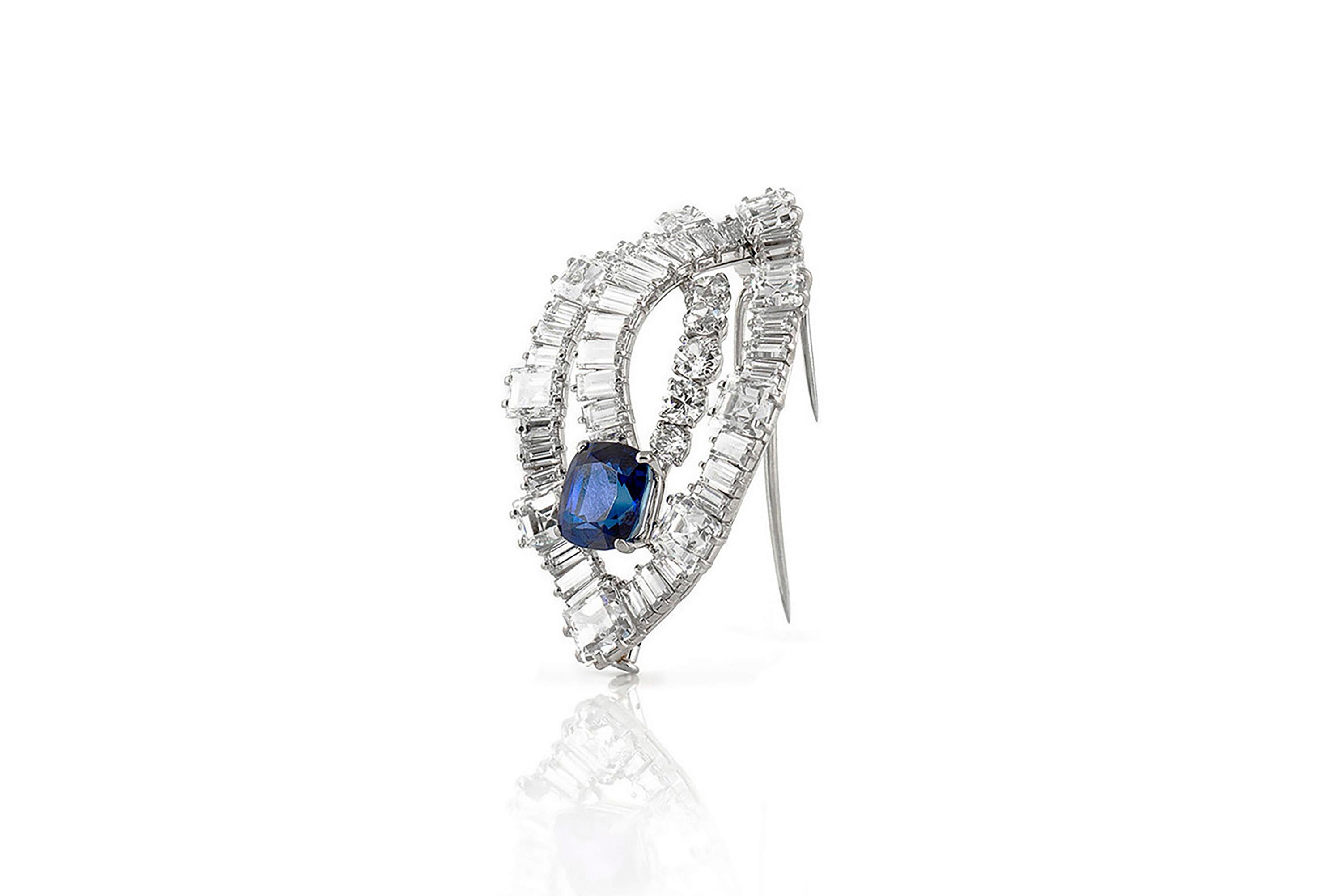 Exquisite Cartier Brooch from 1950's, finely crafted in platinum with natural, cushion cut, Burmese sapphire weighing 7.64 carat with no indications of heat treatment. The center Sapphire is surrounded by baguette, square and round brilliant cut
