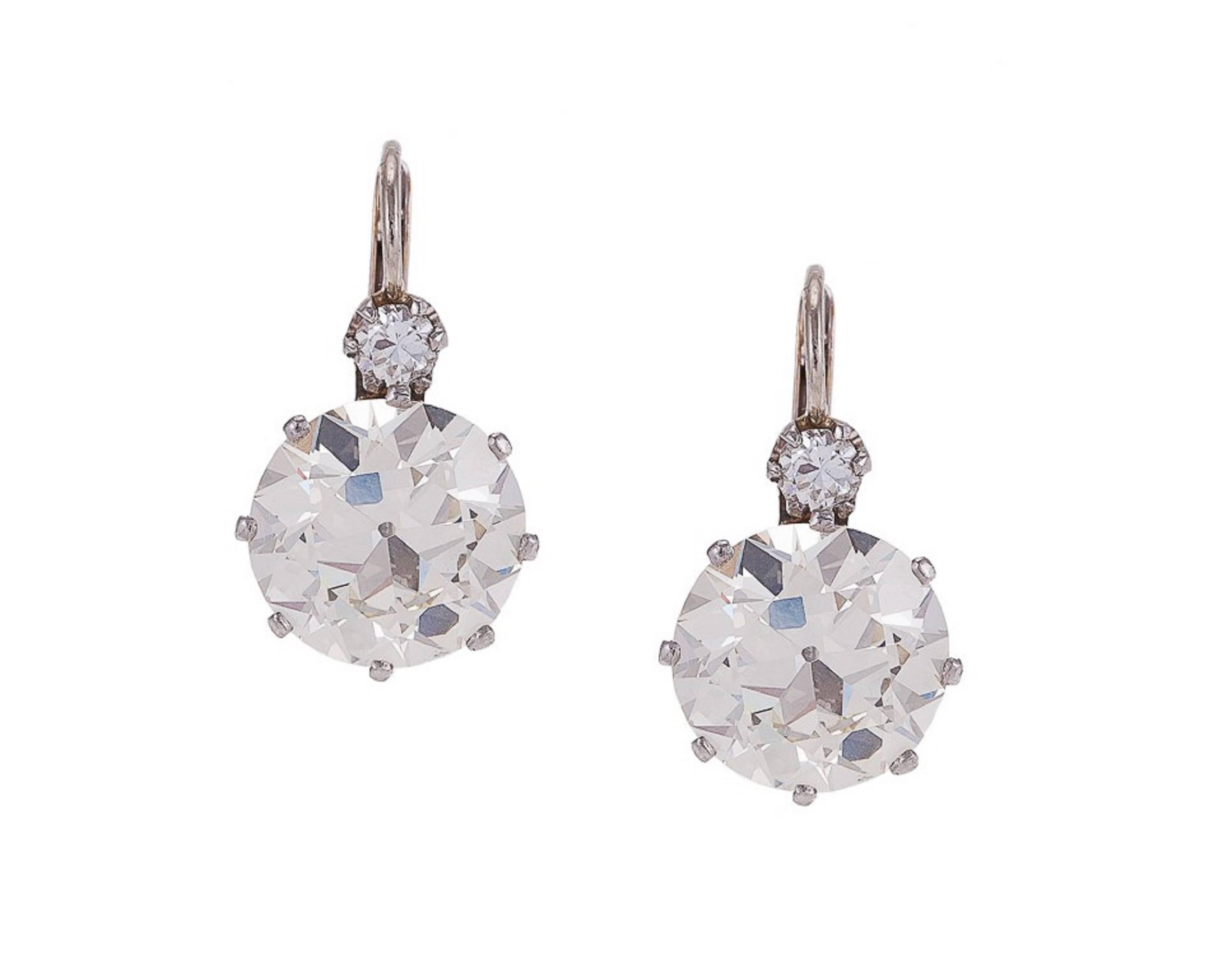 Diamonds circa 1930 in contemporary mountings. Each earring features 1 large old European-cut diamond, (perfectly matched set) weighed loose at 3.70 carats each, color: K-L (faces up 1 - 2 shades whiter) clarity: VS1, suspended from 1 small full-cut