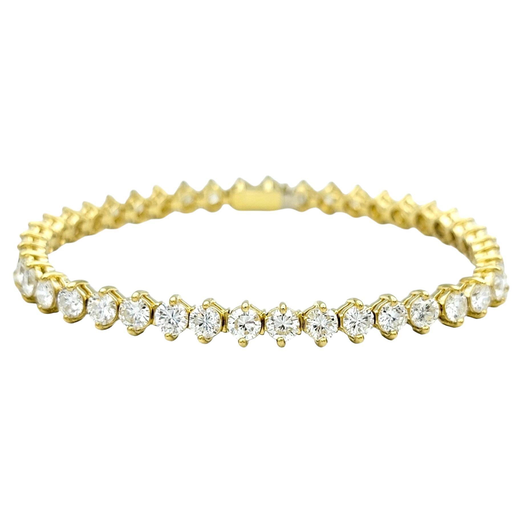 This gorgeous diamond tennis bracelet, exquisitely set in radiant 18 karat yellow gold, is a timeless symbol of elegance and sophistication. Each round diamond is meticulously hand-set in a continuous line, creating a seamless flow of sparkle and