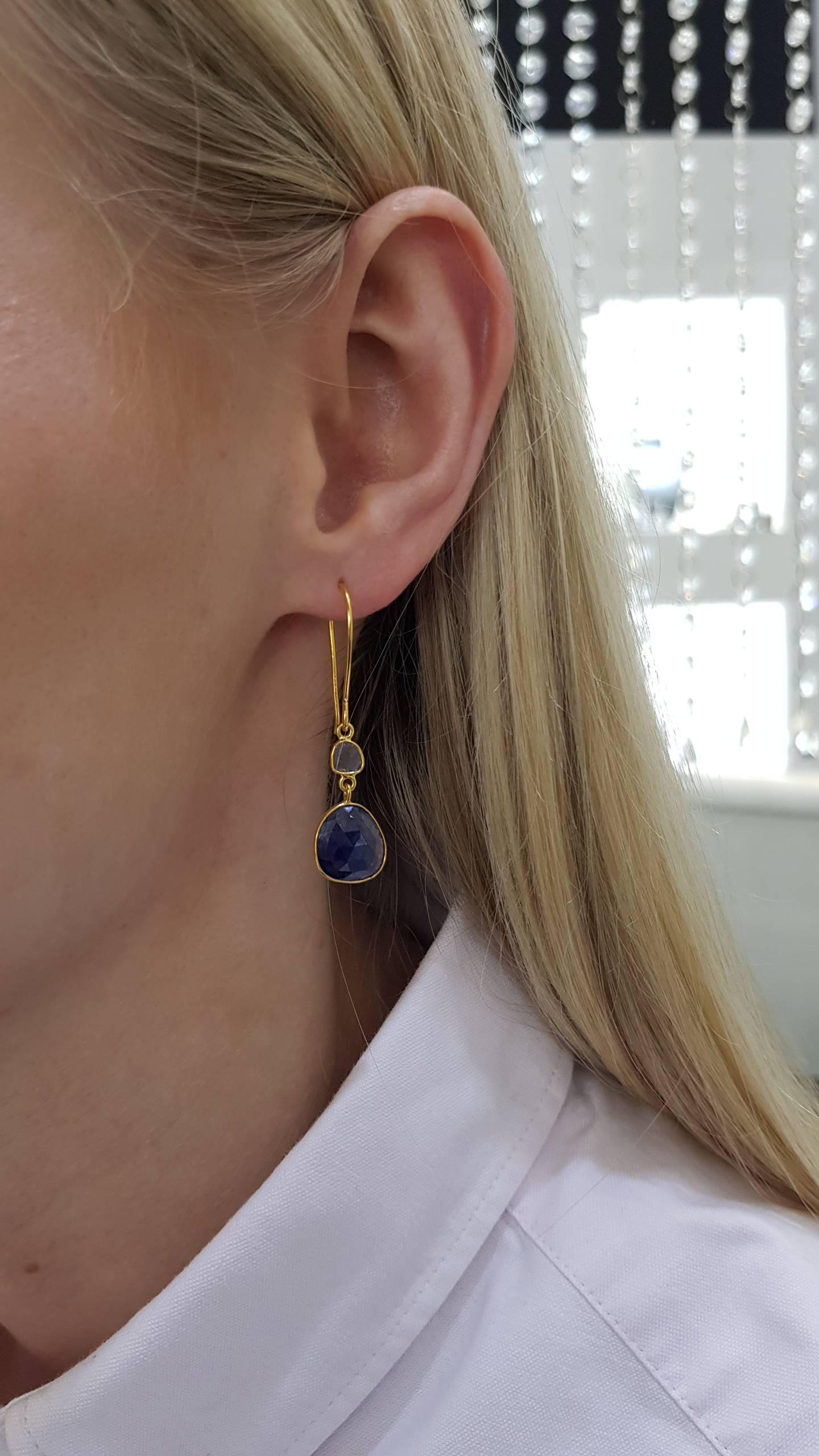 These Gorgeous 7.50 Carat Rose Cut Blue Sapphire Earrings from the Artisan Collection feature 0.18 Carat in two Diamond slices set in 18 Karat Yellow Gold. Each piece is hand made with a unique shaped precious stones. These elegant and lightweight