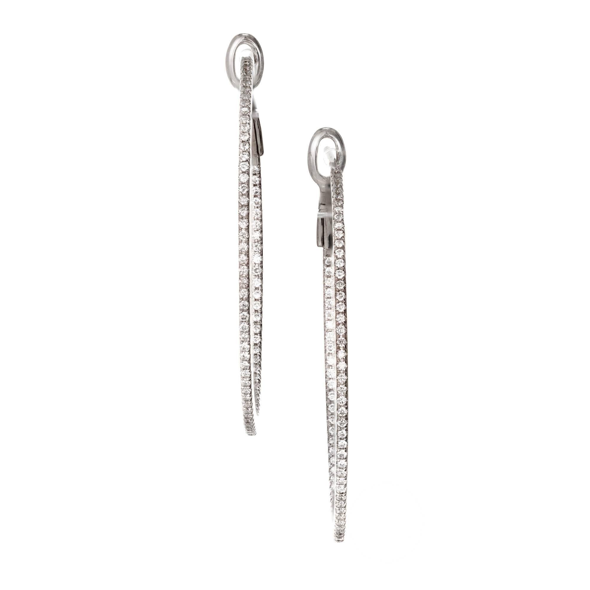 18k white gold diamond hoop earrings set inside and out with round brilliant cut diamonds. 48 diamonds set on the outside with 29 diamonds set on the inside.

154 round diamonds GH VS 1mm Approximate .77 carats
18k White Gold
Tested: 18k
Stamped: