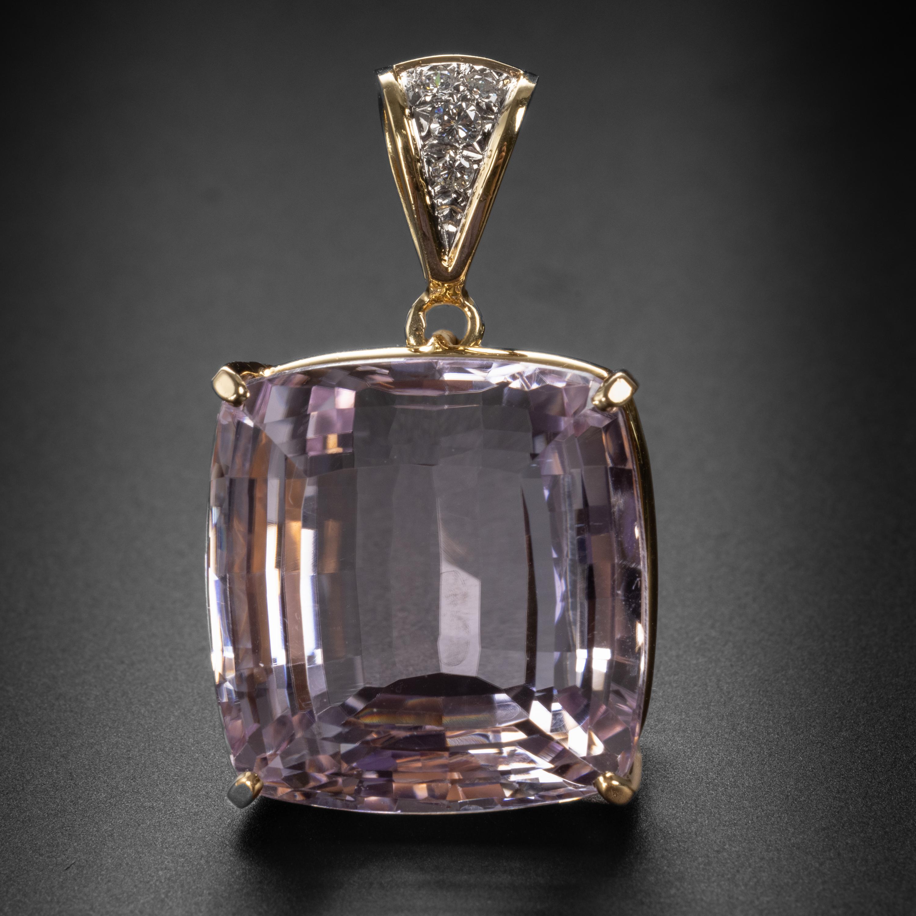 A bold and spectacular pendant. Prong-set within its own handmade 18K yellow gold basket, this massive 77 carat light pink Kunzite gem is dazzling. If you love huge gemstones, you and I think alike. Kunzite was discovered in the early 1900s by the