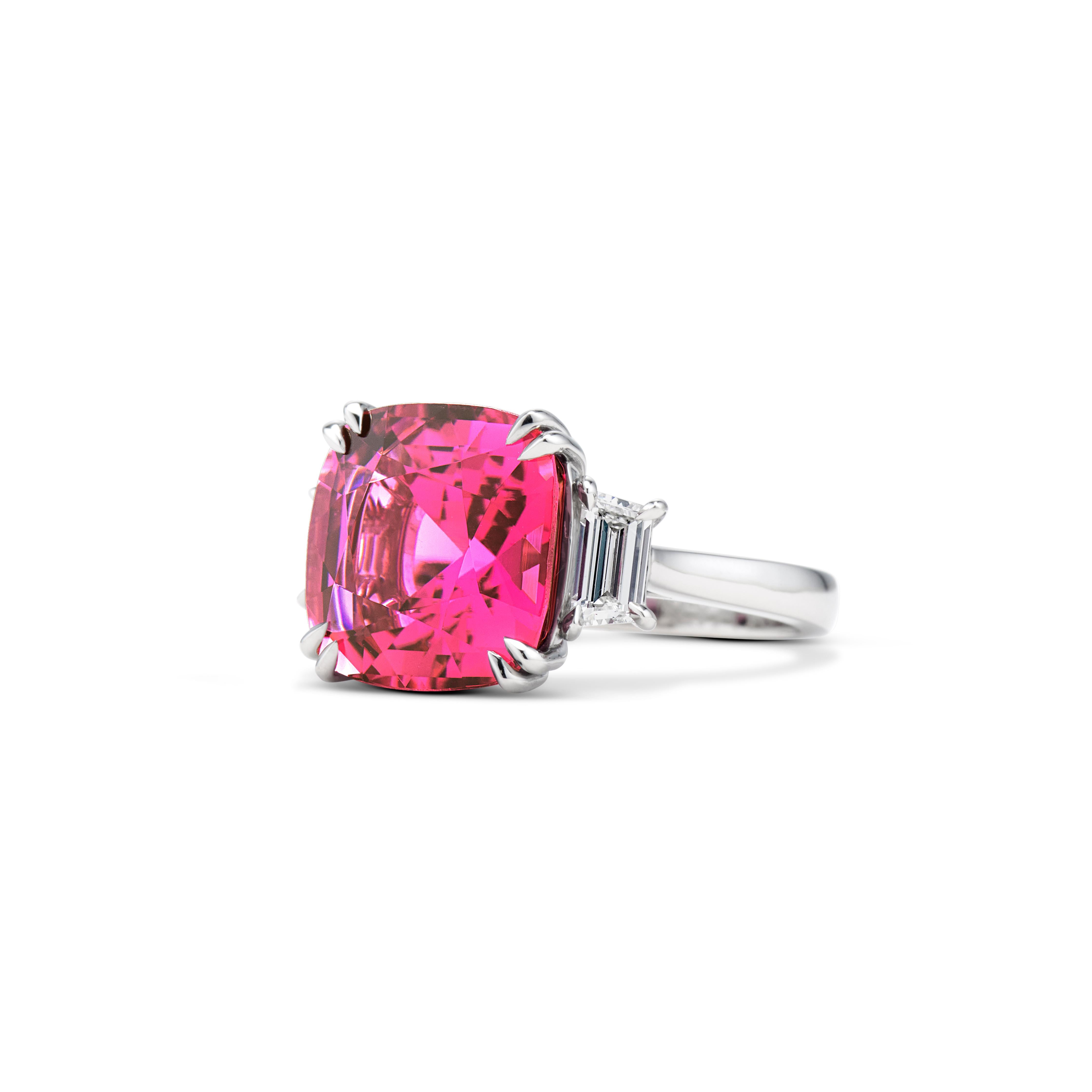 From the Passion & Strength collection.
The centerpiece of the ring is a 7.7-carat pink tourmaline with colorless trapeze-cut side stones. 
Total diamond weight 0.58 carats.
The ring is handcrafted in platinum.
Ring size: 6; resizable upon request.

