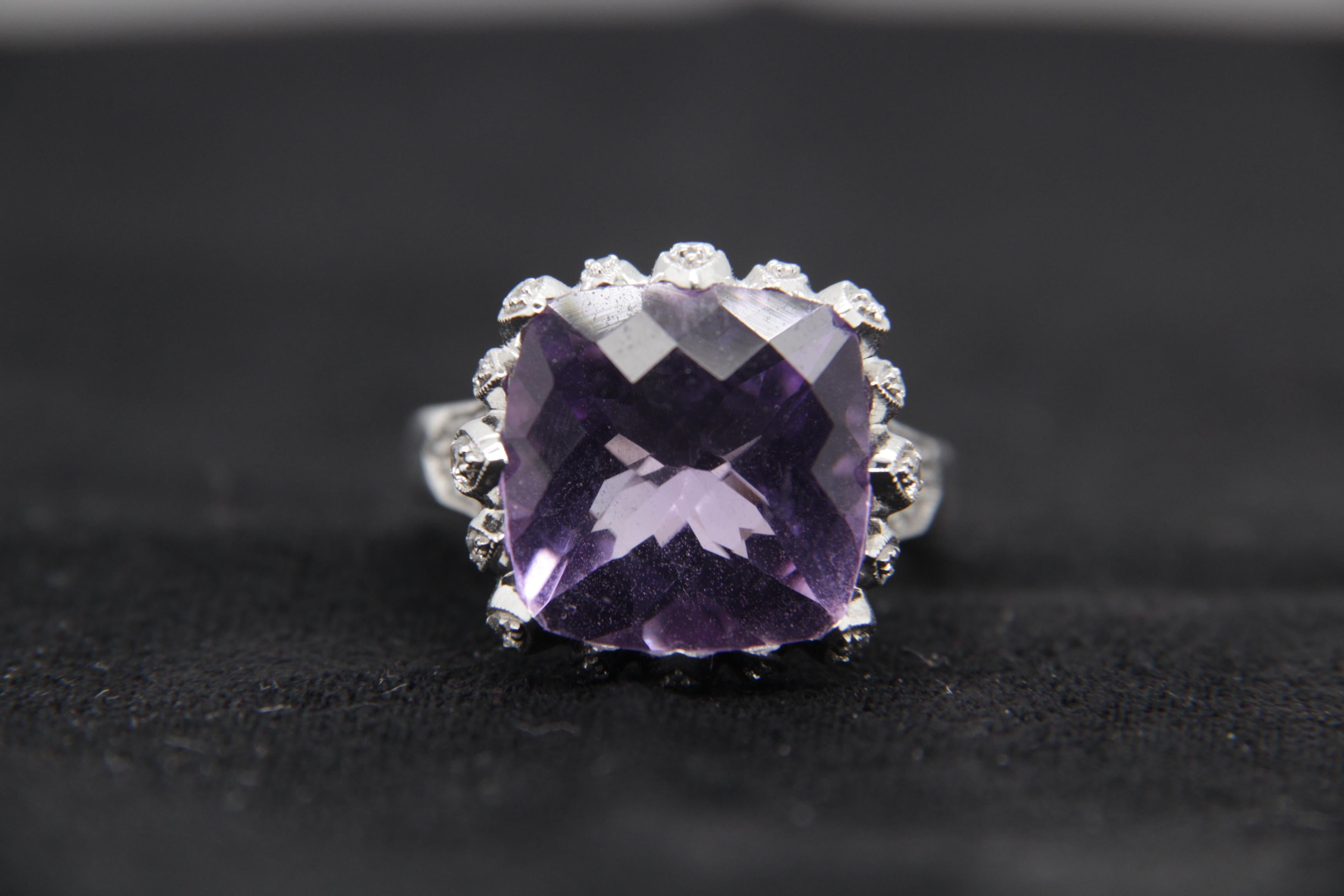 A brand new amethyst and diamond ring in 18 karat gold. The total amethyst weight is 7.70 carats and diamond weight is 0.32 carats. The total ring weight is 9.02 grams.