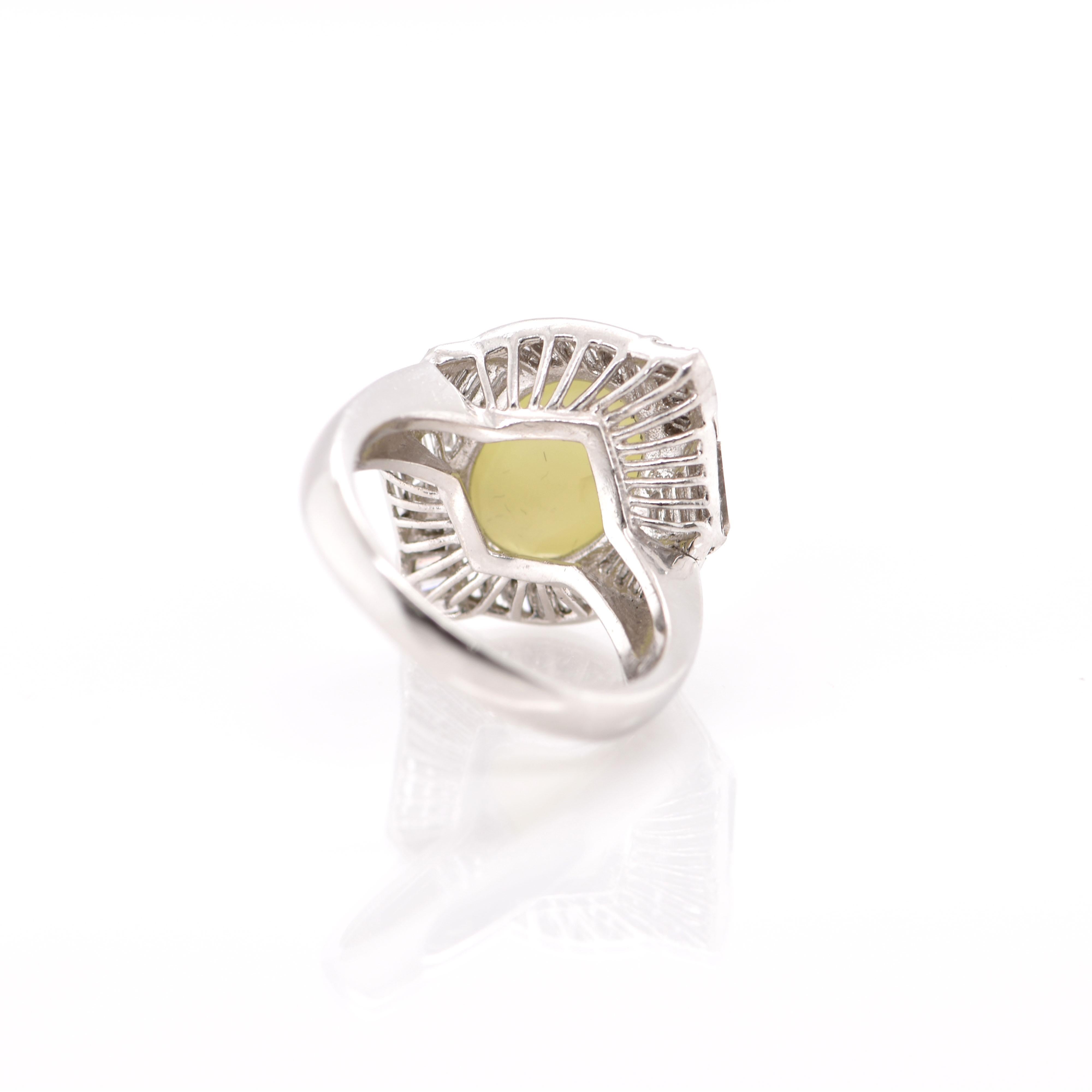A stunning Cocktail Ring featuring a 7.71 Carat Cat's Eye Chrysoberyl and 0.78 Carats of Baguette Diamond Accents set in Platinum. Cat's Eye Chrysoberyl exhibit a unique, naturally occurring phenomena called Chatoyancy or 