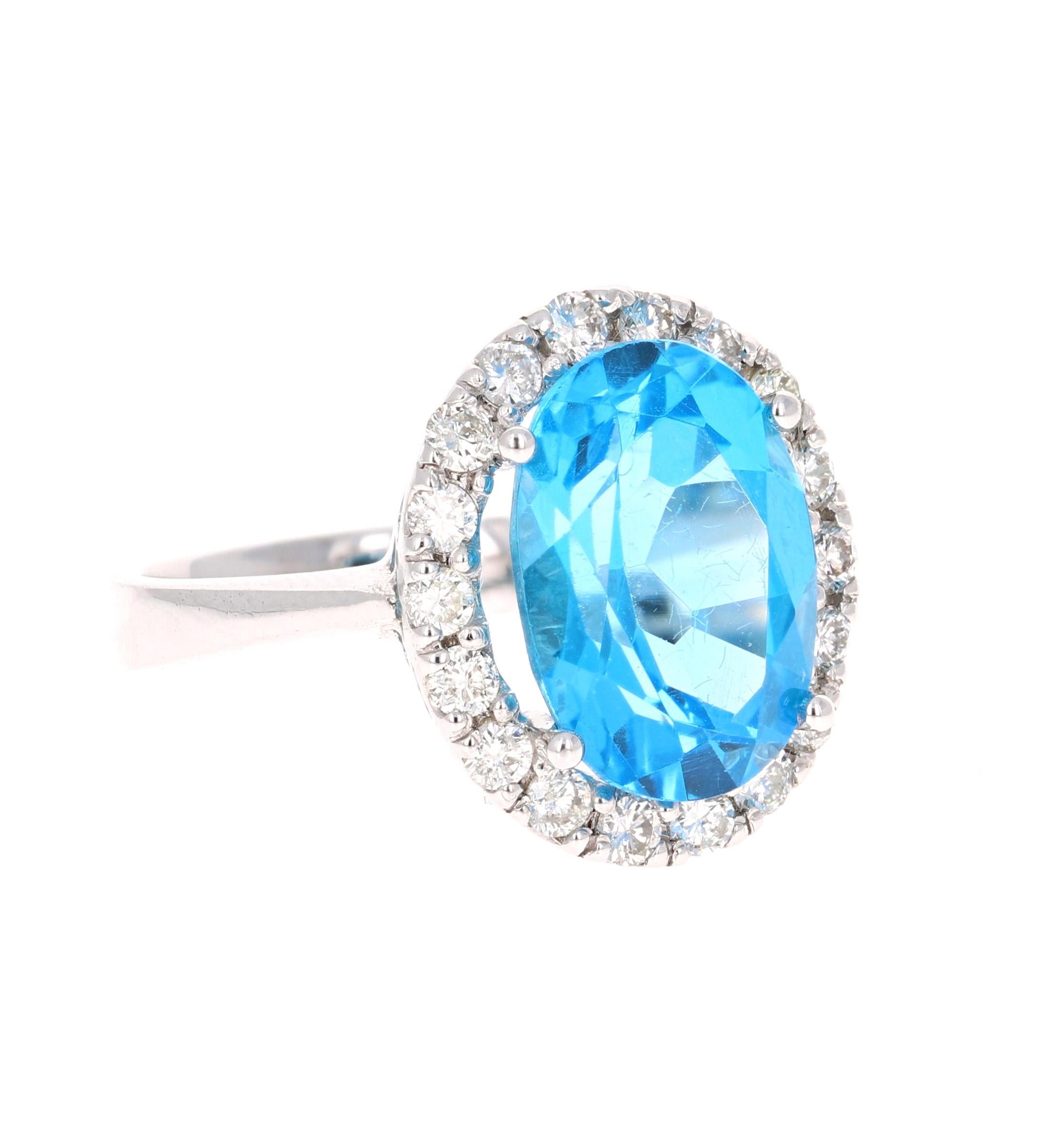 This beautiful Oval Cut Blue Topaz and Diamond ring has a stunning 7.11 Carat Blue Topaz and its surrounded by 18 Round Cut Diamonds that weigh 0.61 Carats. The total carat weight of the ring is 7.72 Carats. 
The setting is crafted in 14K White Gold
