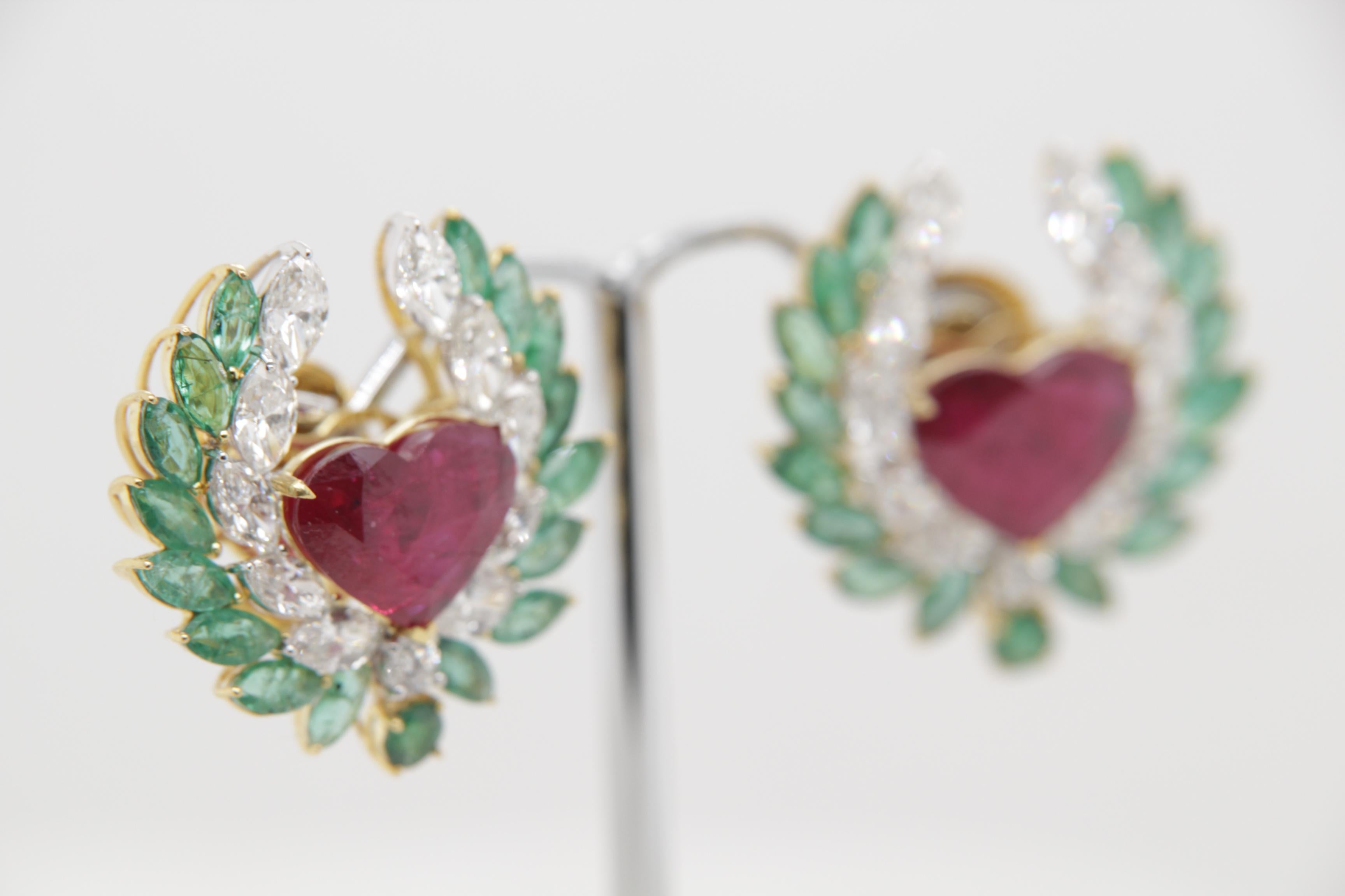 A brand new thai ruby earring mounted with emeralds and diamonds in 18 karat gold. The one ruby weighs 3.51 carat is certified by Carat Gem Lab (CGL) as natural, 'No heat' and 'Intense Red'. The total ruby weighs 7.72 carats. The total emerald