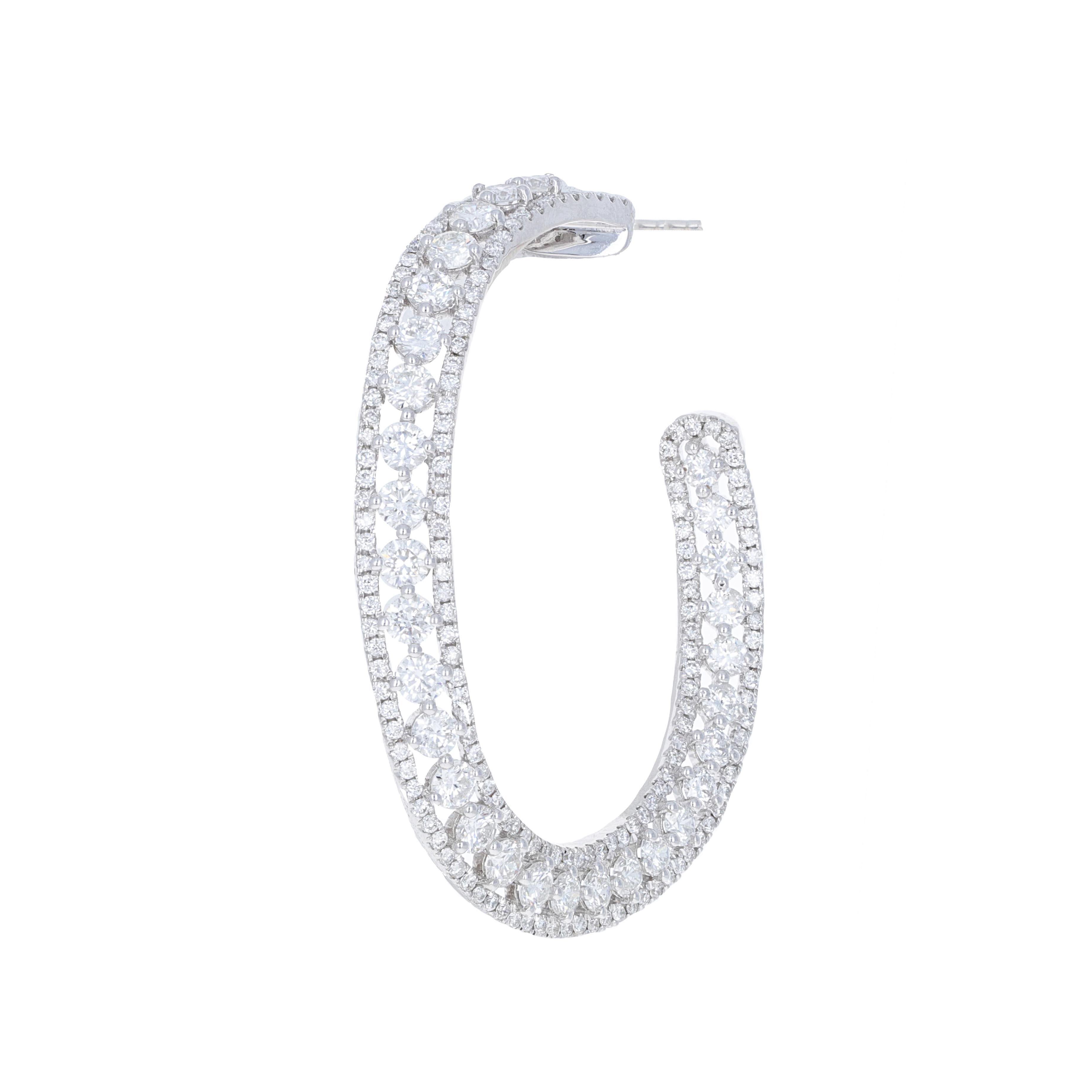 18 karat white gold diamond hoop earrings. These hoops have 7.72 carats of round brilliant white diamonds. The design of the hoops is modern and chic. You can dress these hoops up or down and have them as an everyday pair of earrings. They are a