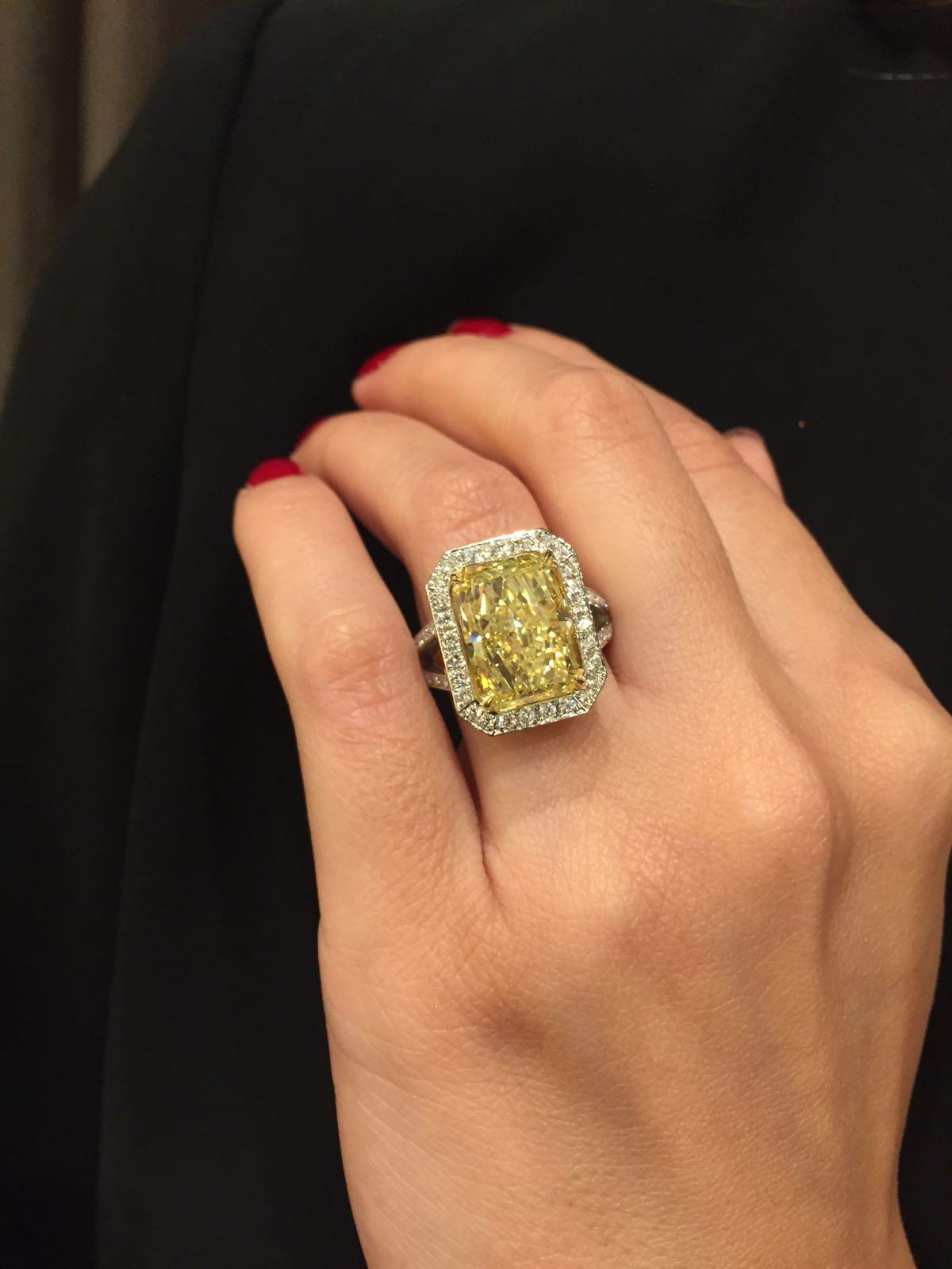 Truly extraordinary quality of craftsmanship and design make this amazing piece really unique. The GIA certified Radiant Cut 7.73 carat Fancy Yellow center diamond has a beautiful color and is framed by round brilliant diamonds. The mid-section of