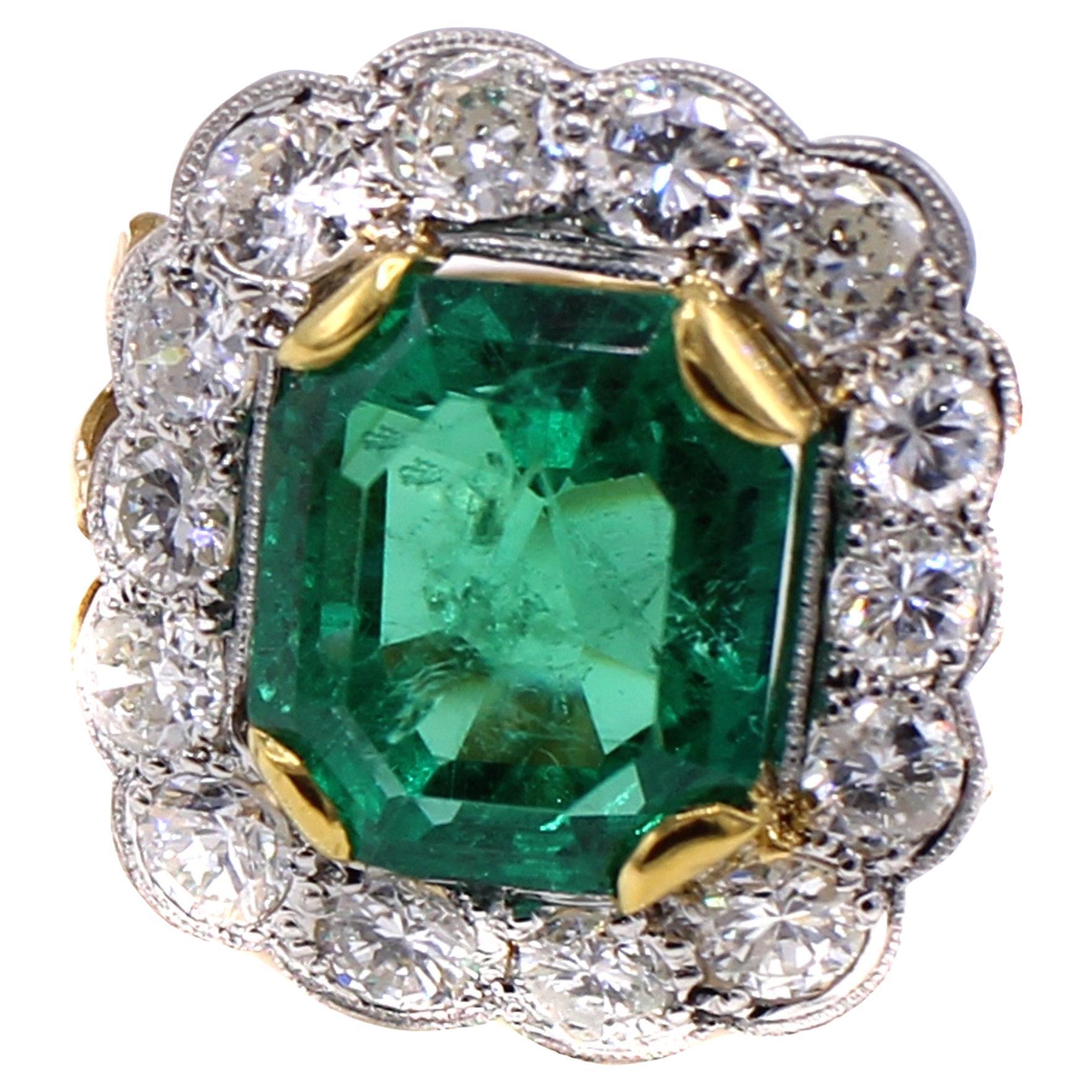 A beautiful step cut emerald cut Colombian emerald is the center piece of this gorgeous vintage ring from ca 1945. The luscious well saturated forest green emerald weighing 7.71 carats is accompanied by a report from the AGL stating that the origin