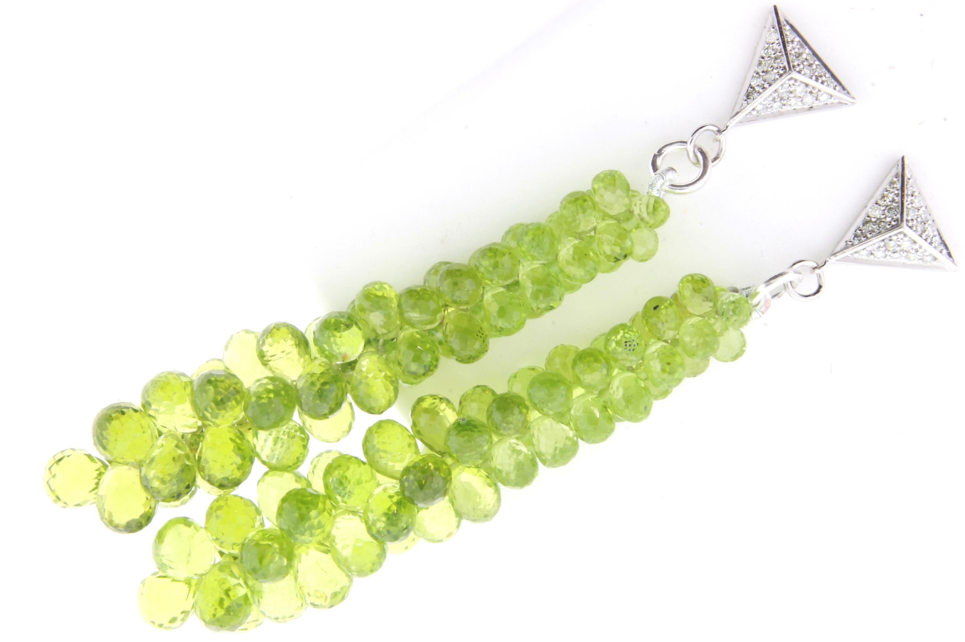From our briolette earring collection!

Material: 14k White Gold 
Stone Details: 2 Briolette Shaped Peridots at 77.35 Carats Total
Diamond: 42 Brilliant Round Diamonds at 0.25 Carats - SI Quality / H-I Color
Earring Length: 3 inches

Fine